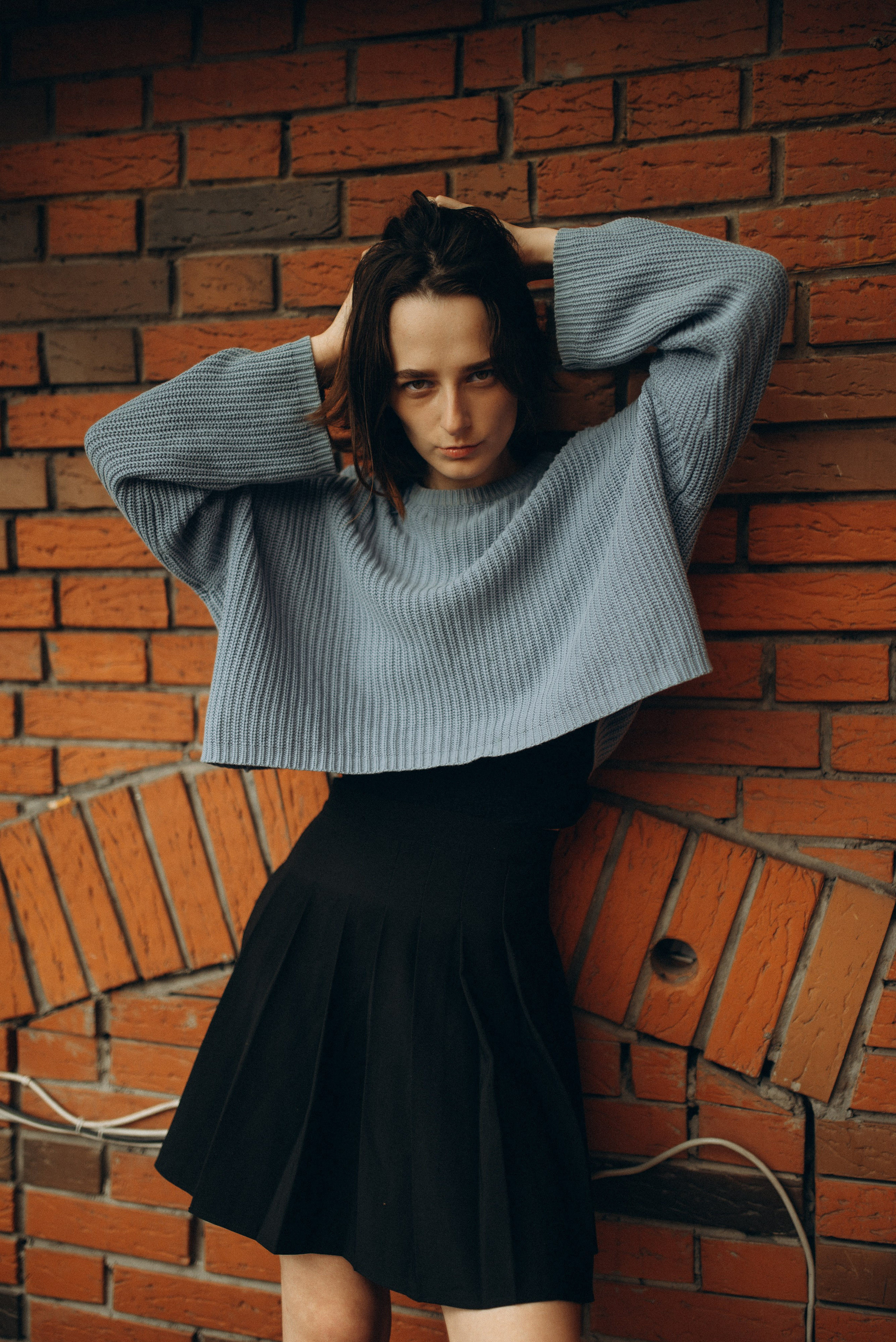 Девушка в голубом свитере на фоне кирпичной стены и черной винтовой лестницы, портретная фотосессия в индустриальном стиле. Фотосессия в Новосибирске.4.