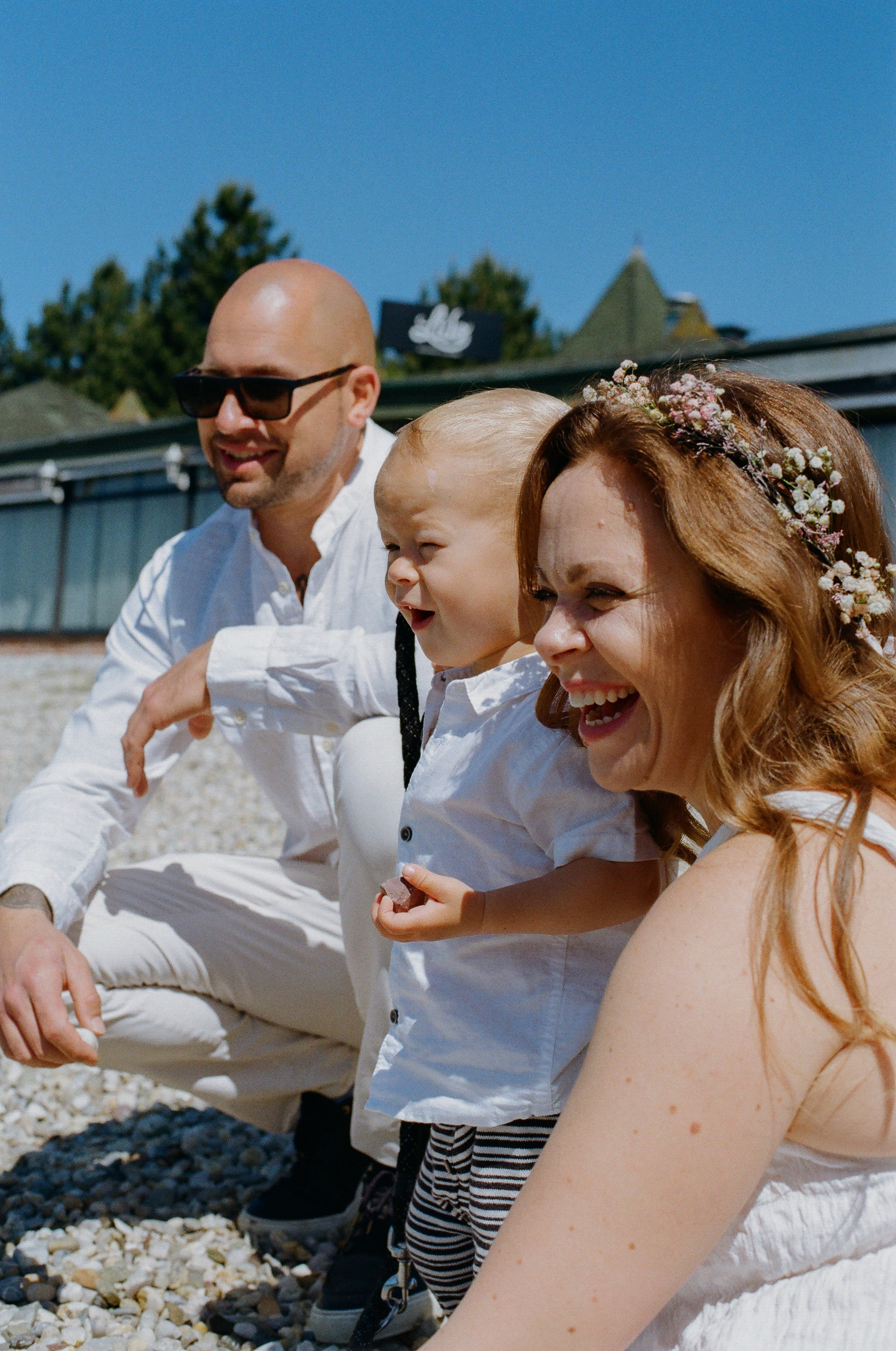 a family laughing at something and having an intimate moment together