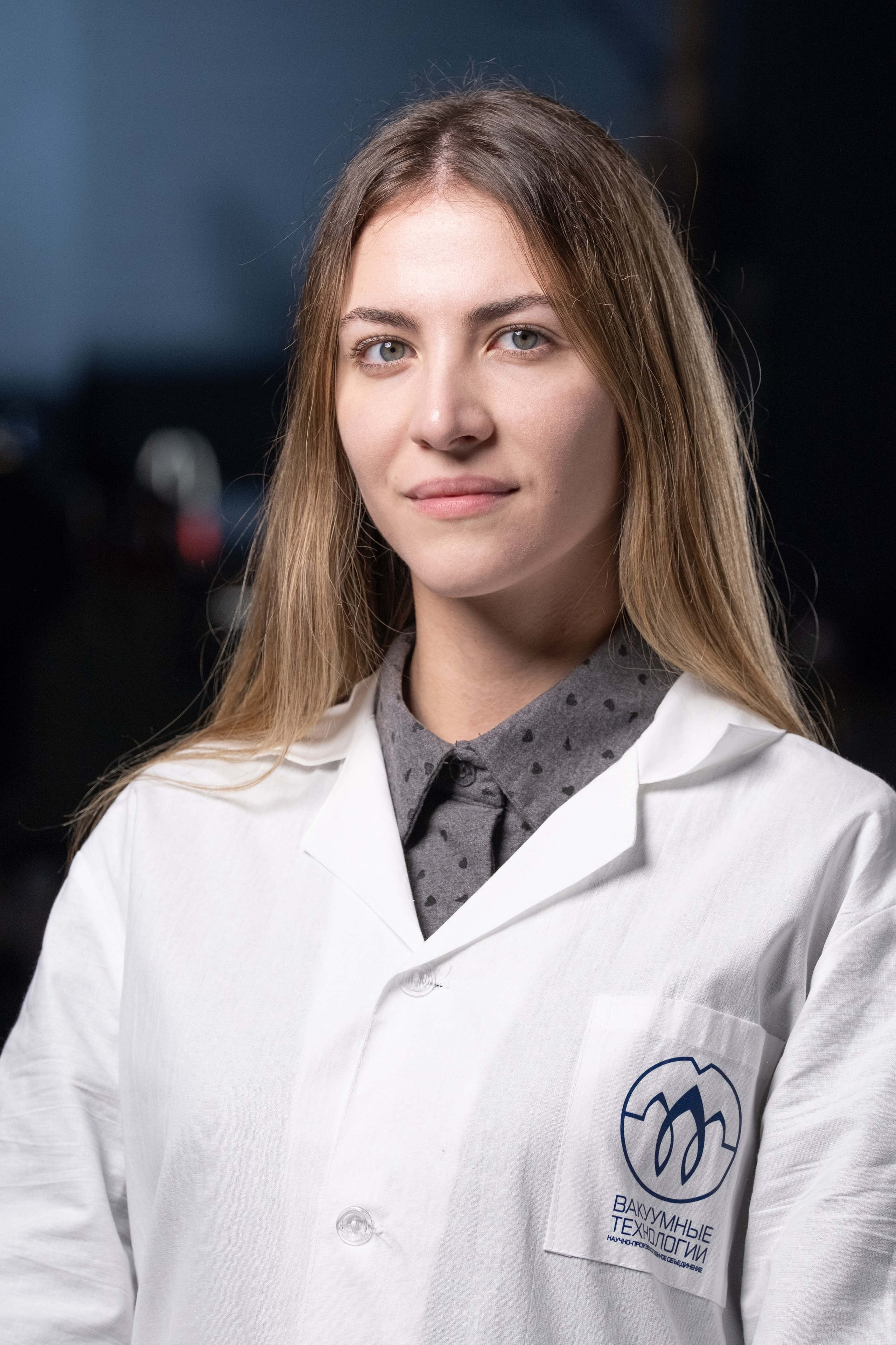 Деловой портрет: молодая женщина-ученый или инженер в лабораторном халате, профессиональная фотосессия для технологических компаний и исследовательских центров, фотограф для корпоративных портфолио.