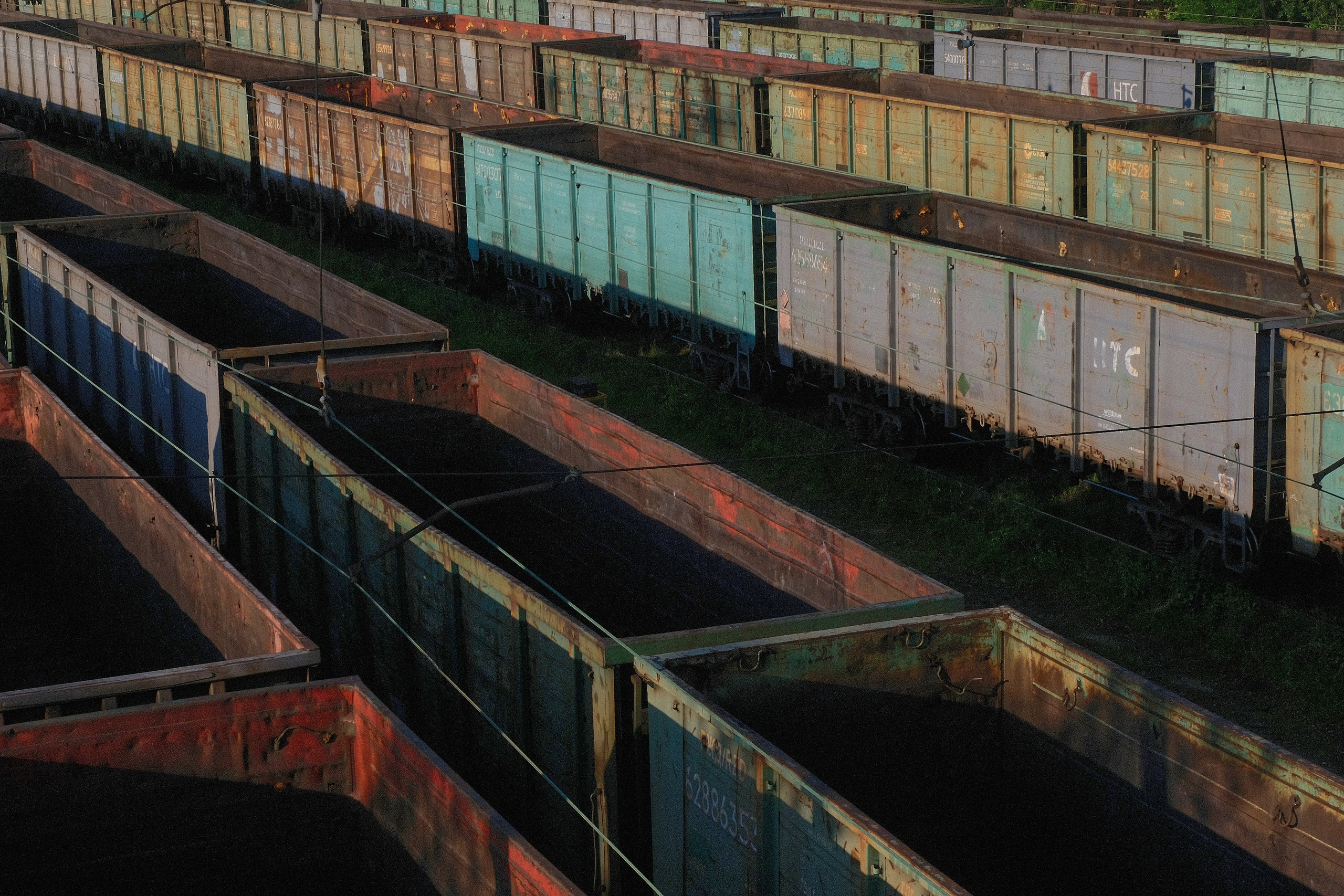 bunch of train containers sitting on a track