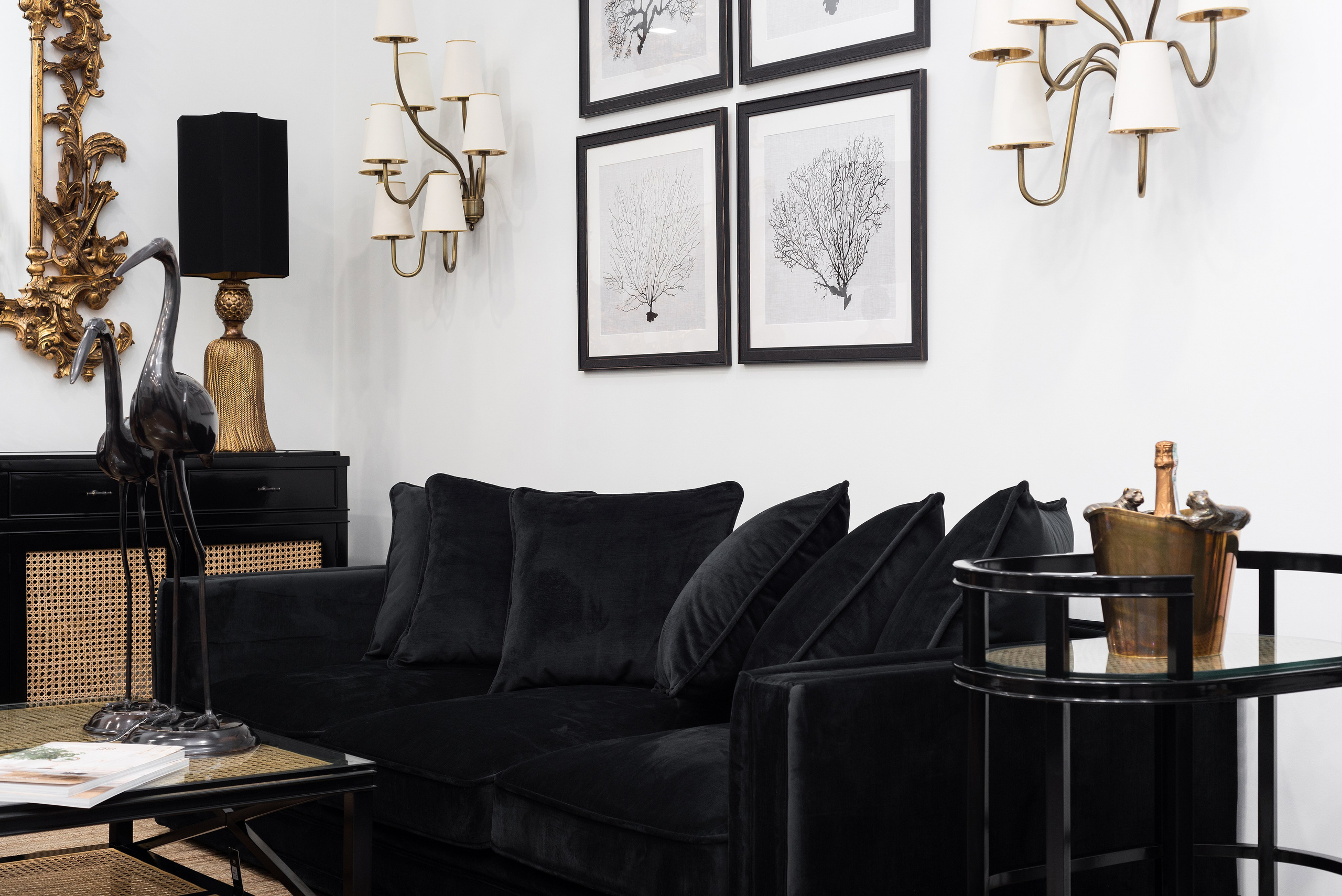 Чёрный диван и настенные постеры в современном интерьере — интерьерная съёмка офиса или салона, Алматы