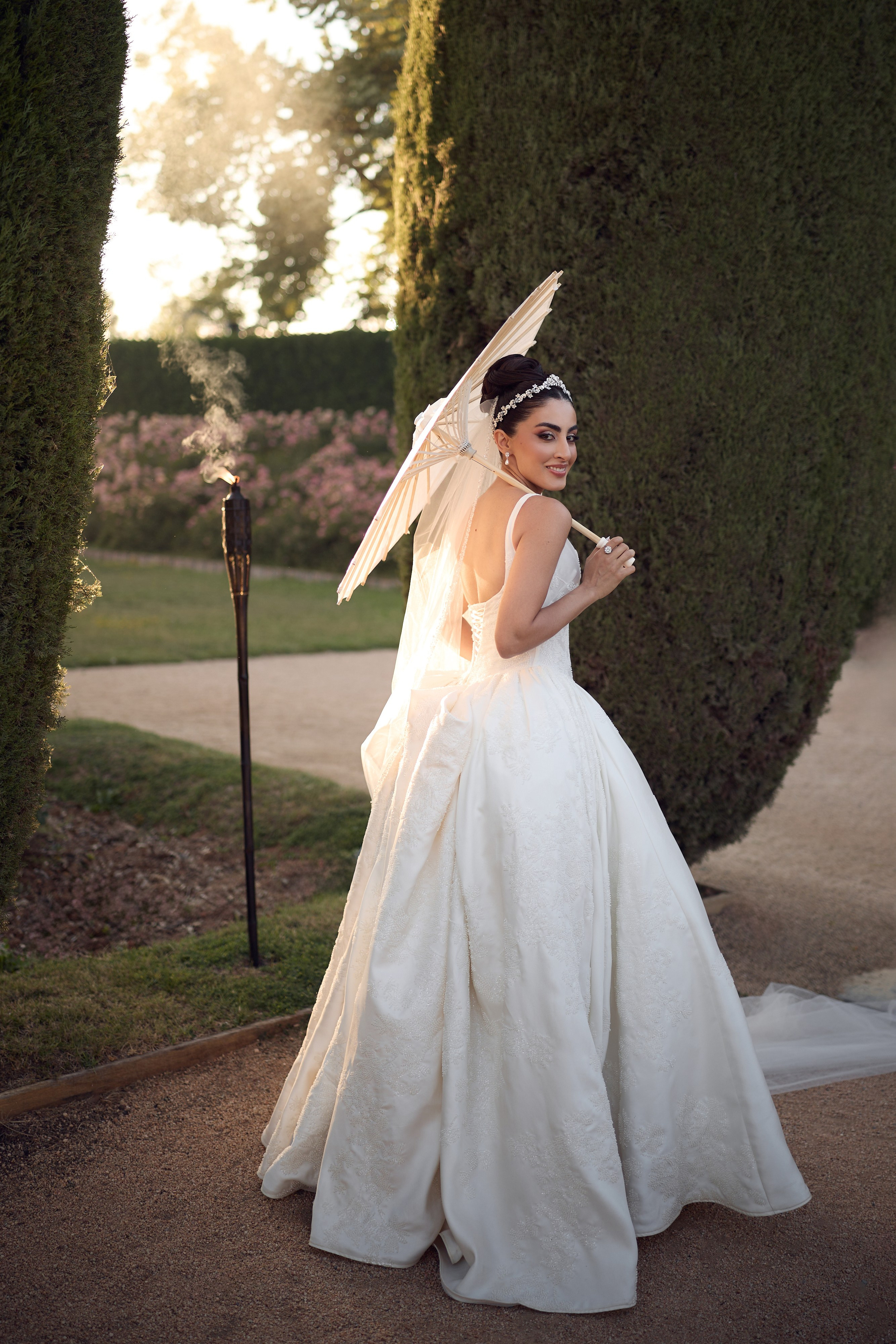 Bride raising her bouquet during an outdoor wedding celebration
