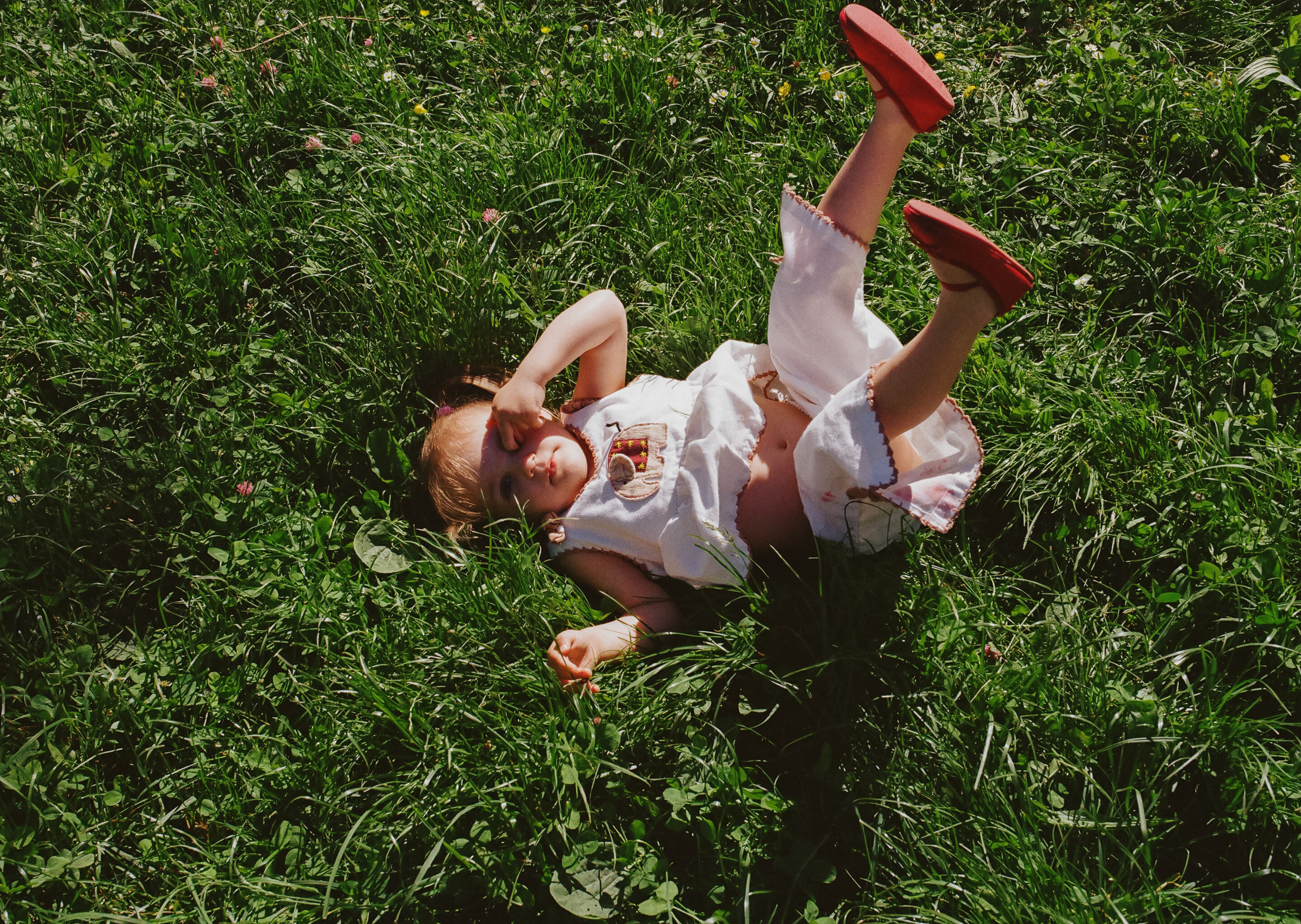 a girl lying in the grass and fooling around