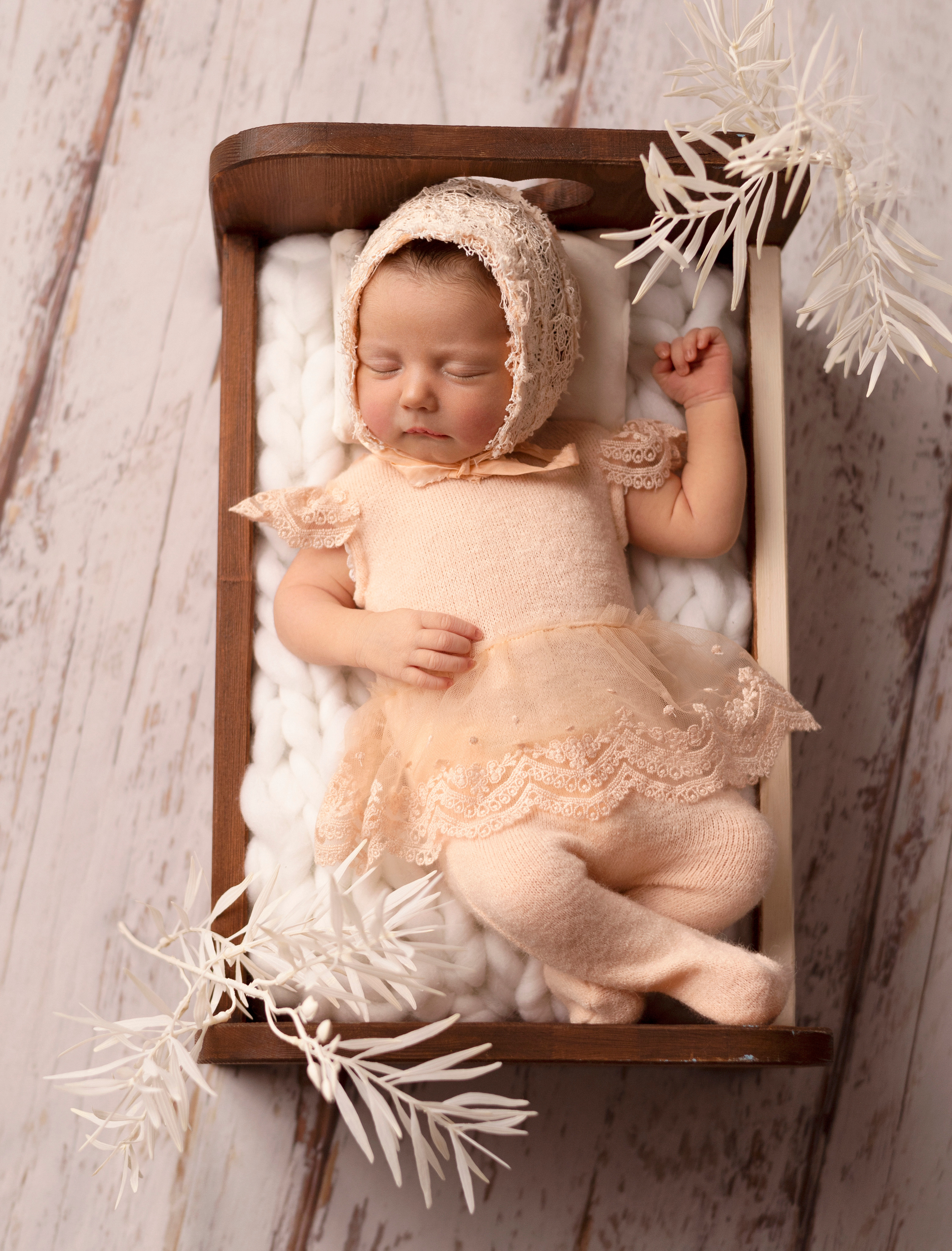 новорожденный сладко спит на белом фоне в кроватке newborn фото фотосессия на спине