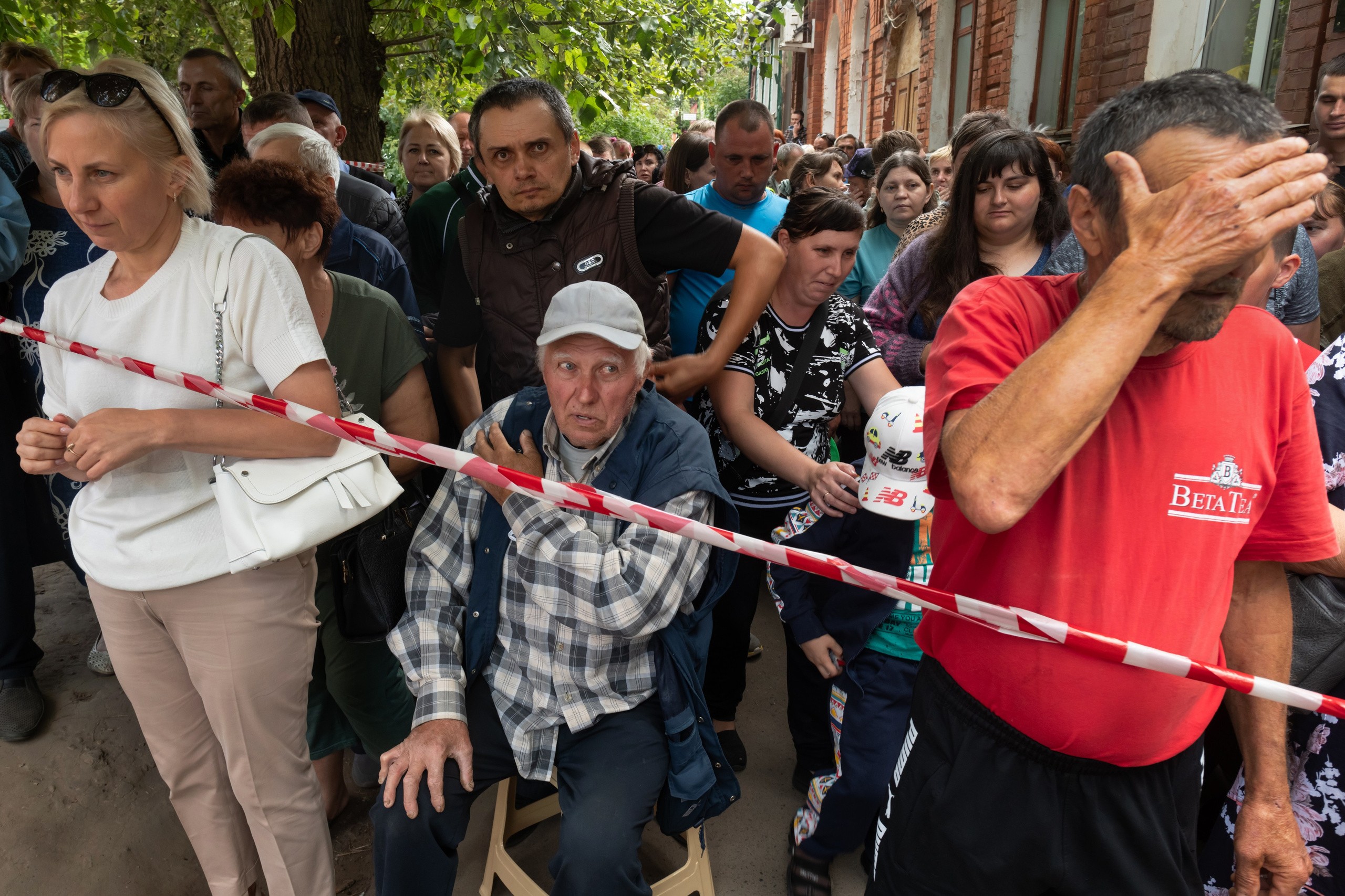People evacuated from a fighting between Russian and Ukrainian forces queue to receive humanitarian aid at a distribution center in Kursk, Russia, Monday, Aug. 12, 2024. (AP Photo)