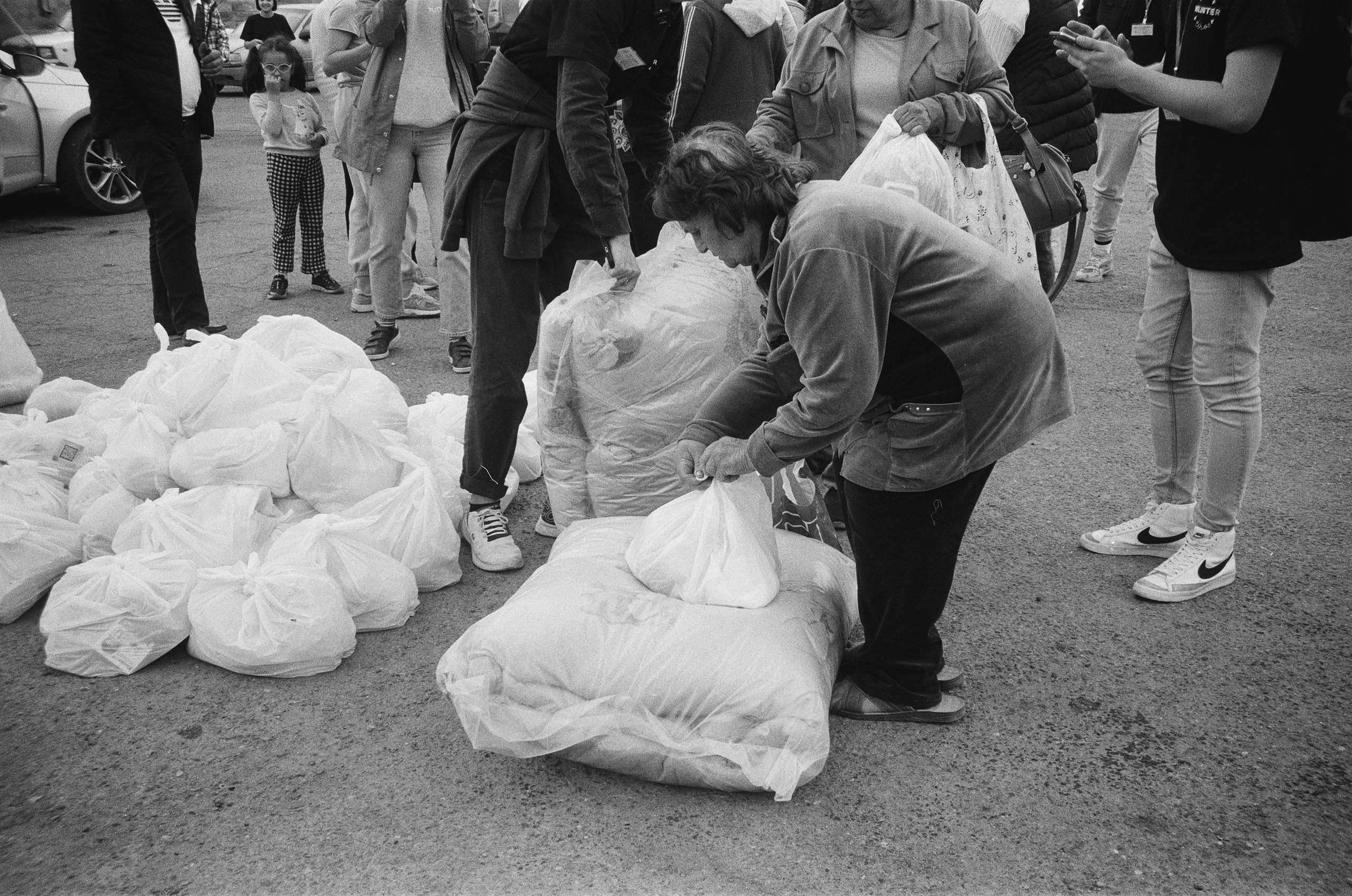 A woman is receiving humanitarian aid from volunteers in Goris