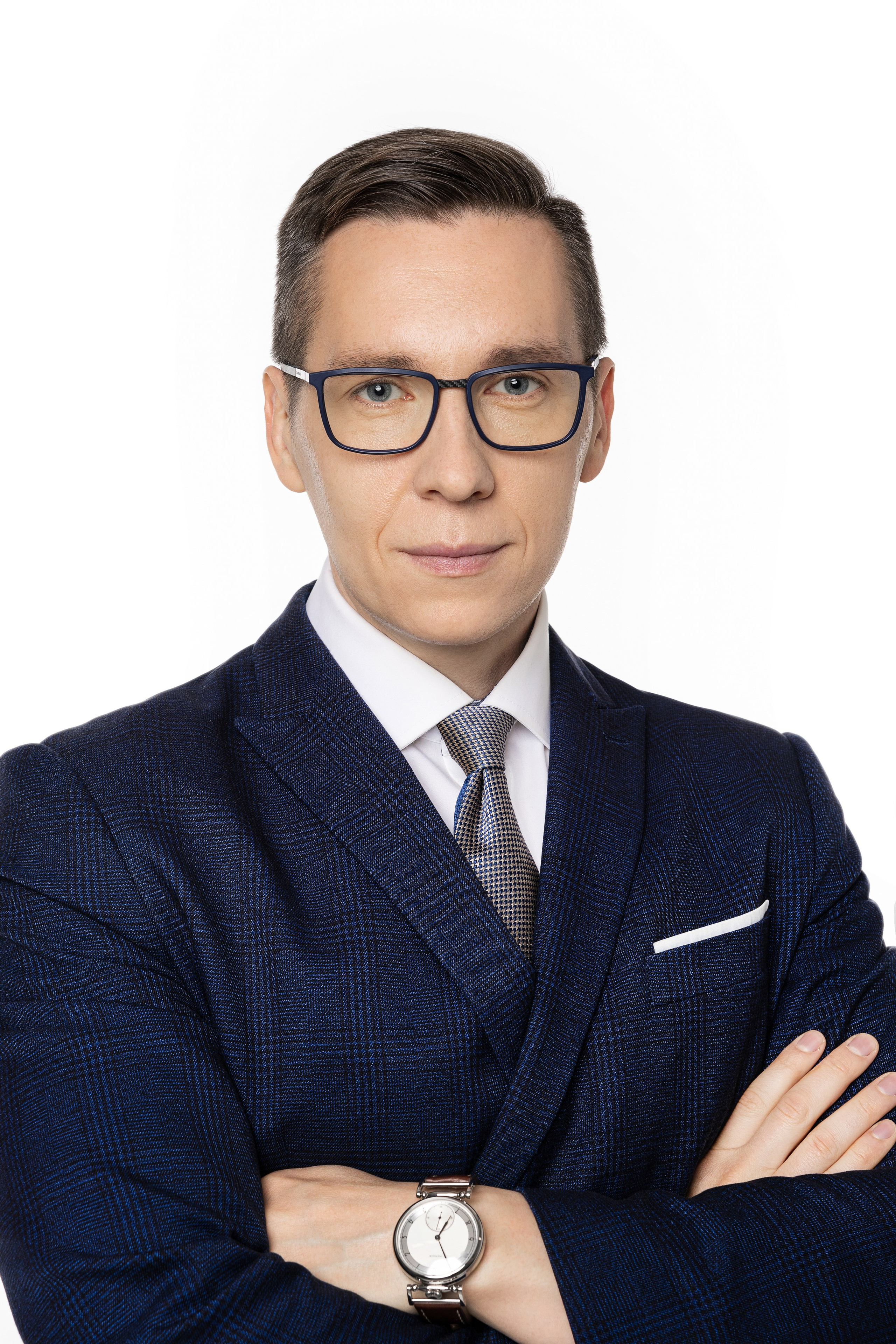 Бизнес-портрет мужчины в синем костюме и очках на белом фоне