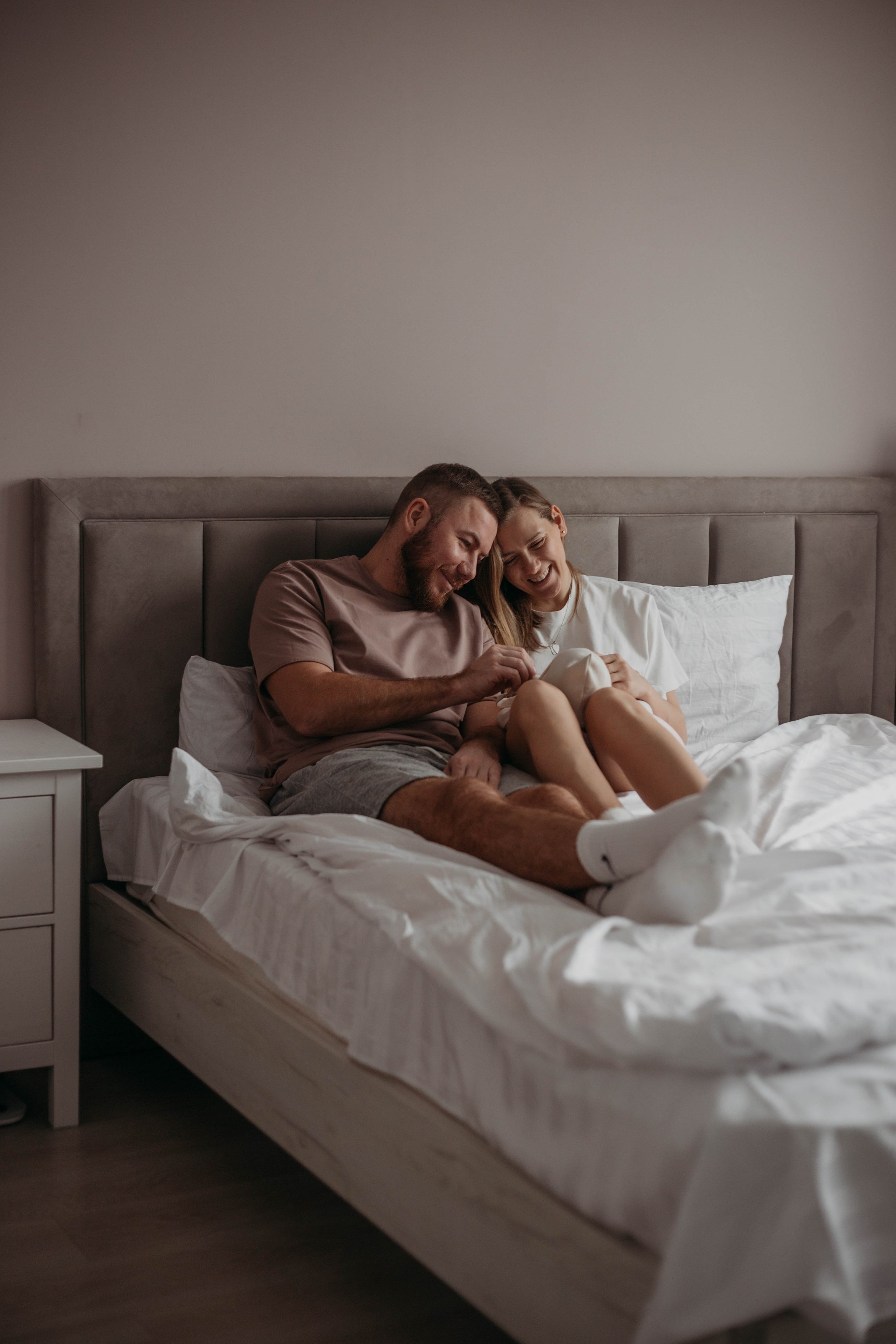 муж и жена смотрят на новорожденного