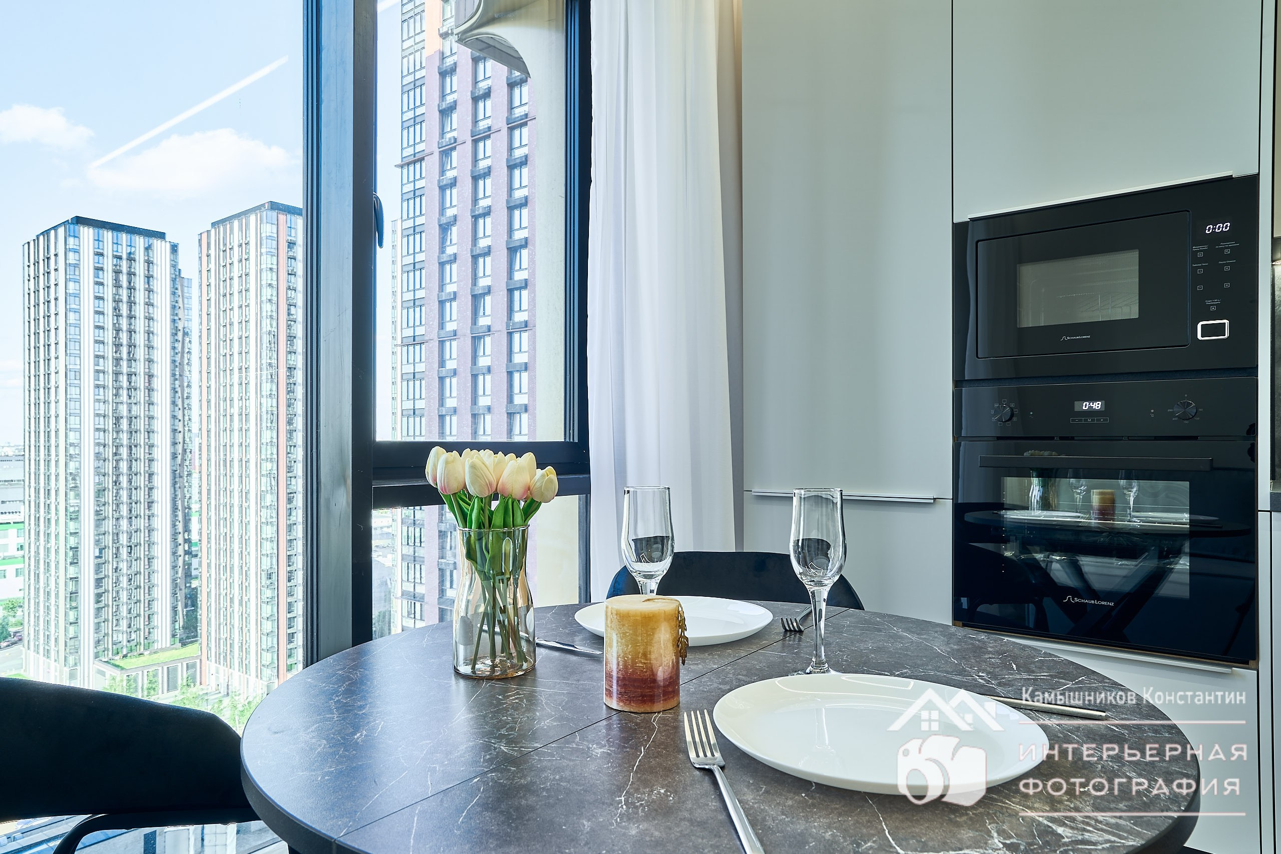 Интерьерная фотография с крупным планом обеденного стола в кухонной зоне в гостиной жилых апартаментов в ЖК Метрополия в Москве