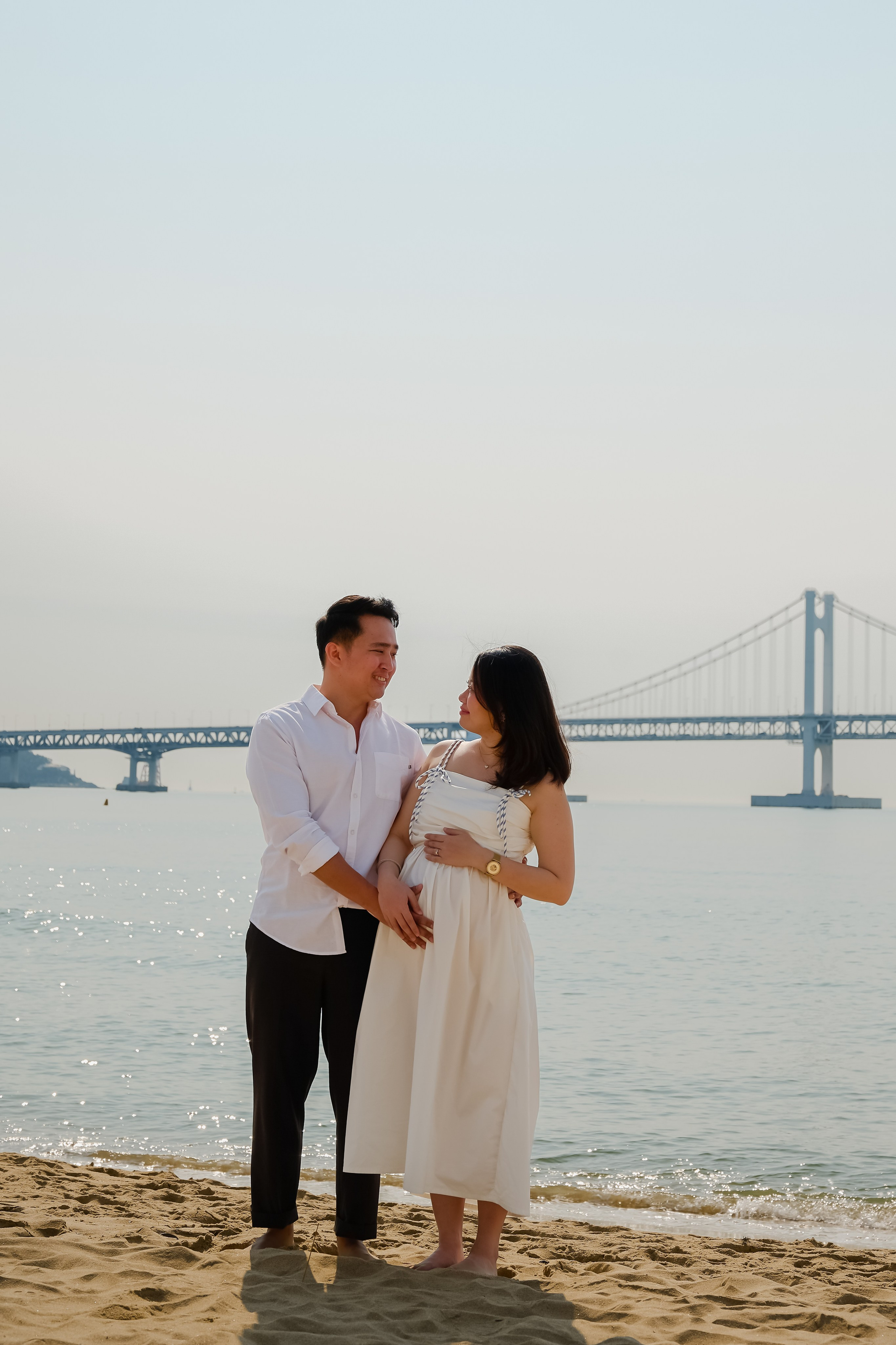 Couple on Gwangalli Beach with a view of Gwangan Bridge, Busan · 부산 여행 스냅