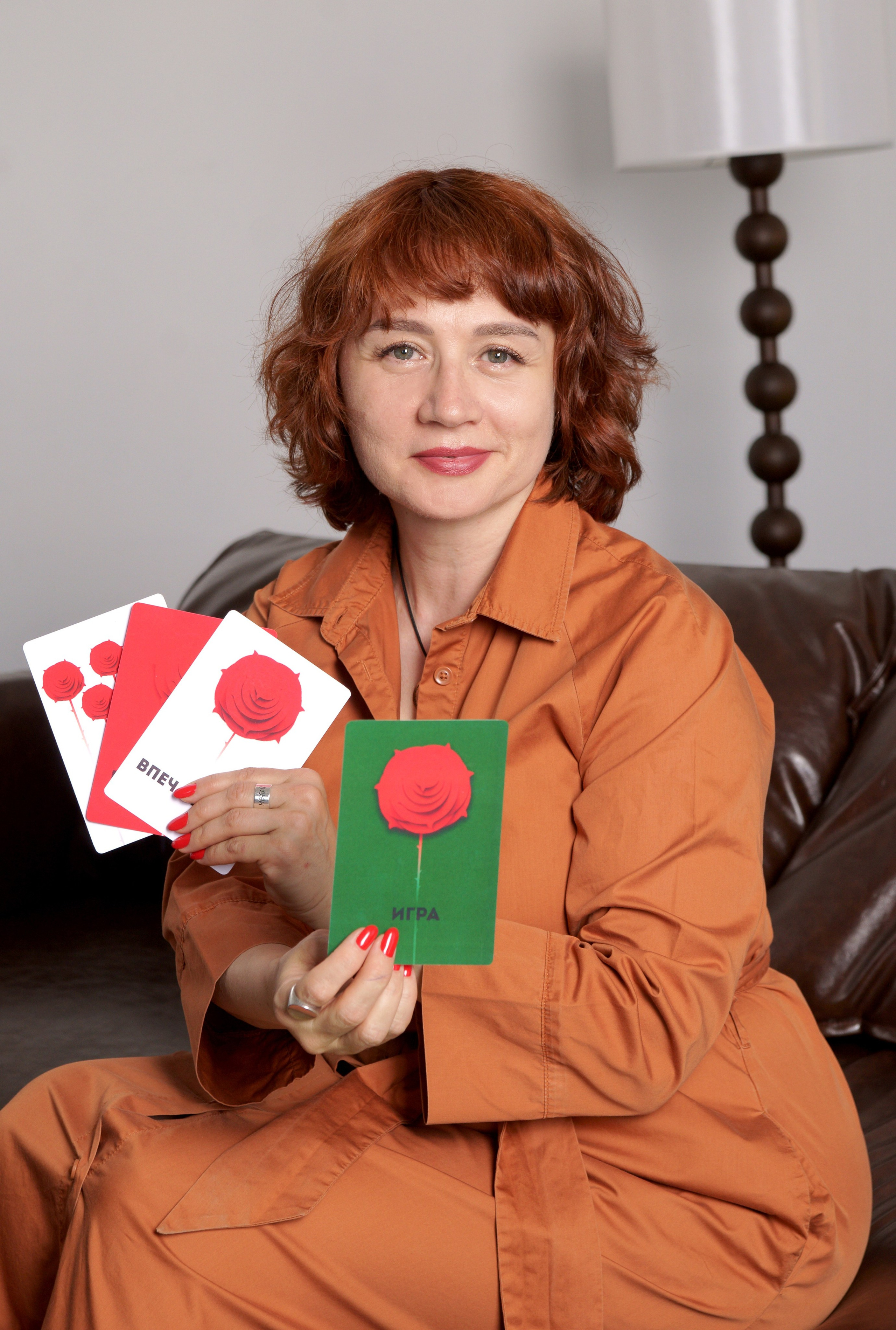 Контент съемка - женщина сидя показывает разные карточки