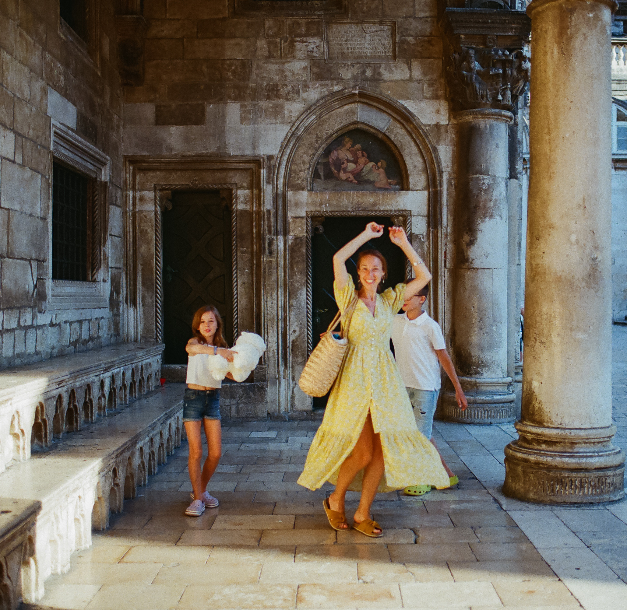 mother with her children having fun and twirling around