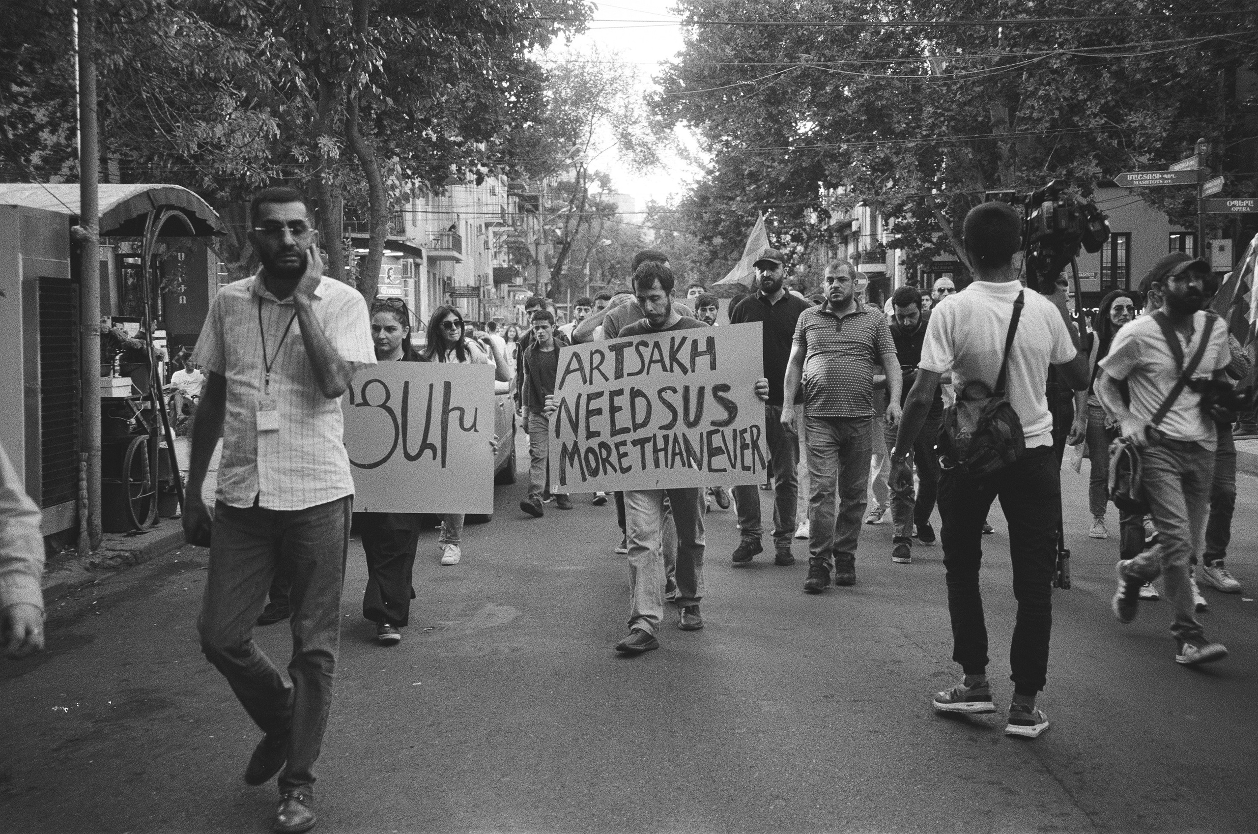 The protesters are marching down a street lined with numerous bars and restaurants, calling on people to join the protests in support of Artsakh