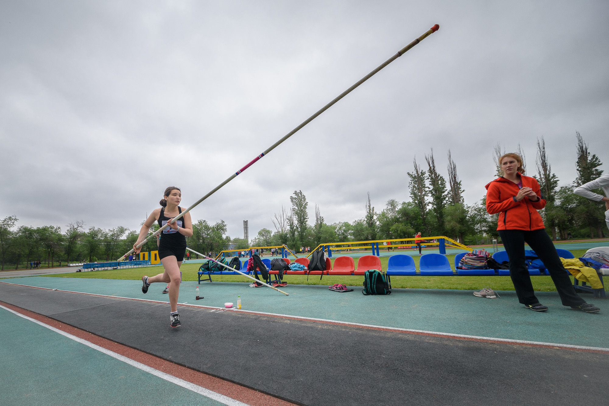 Прыгунья с шестом разбегается перед прыжком