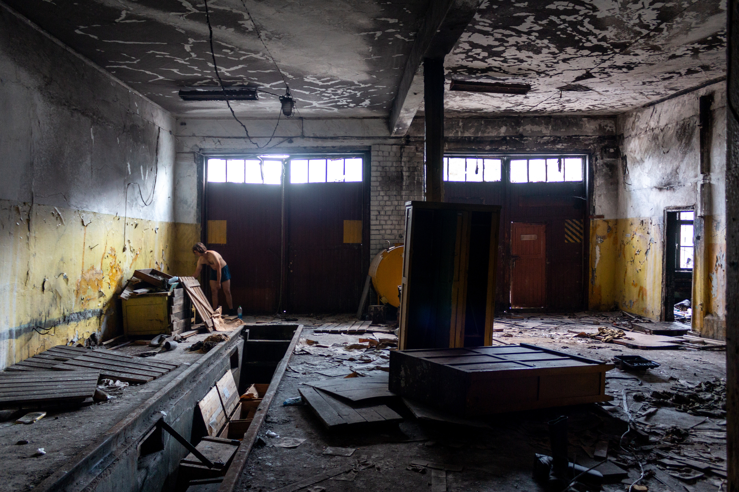 Edik washing the dishes after a breakfast in an abandoned fire department's station.