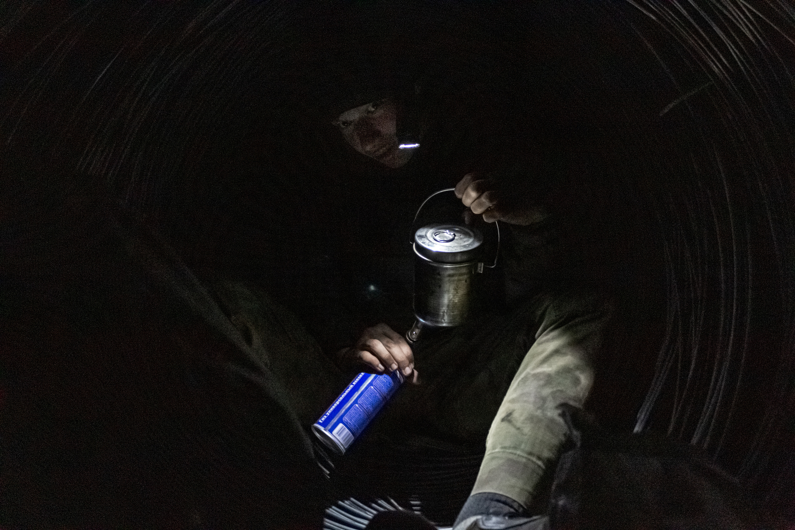 Ilya heating up the water for instant noodles in the wire tunnel.