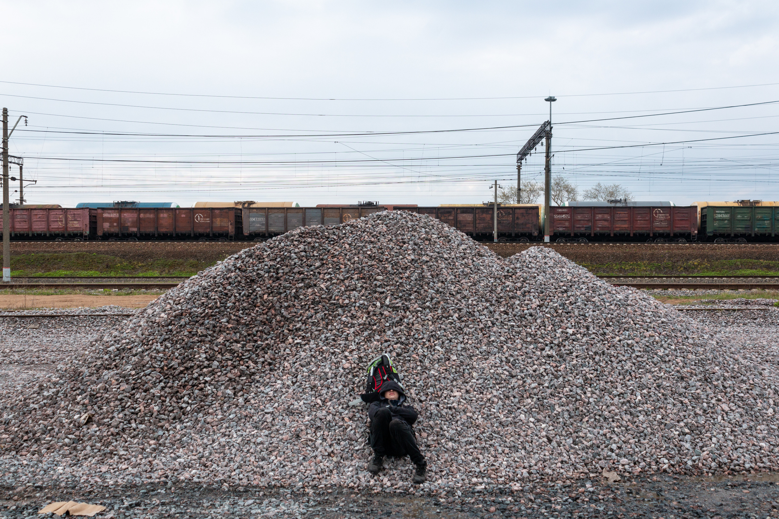 Senya sleeping on the crushed stone waiting for the train that will go in the right direction.