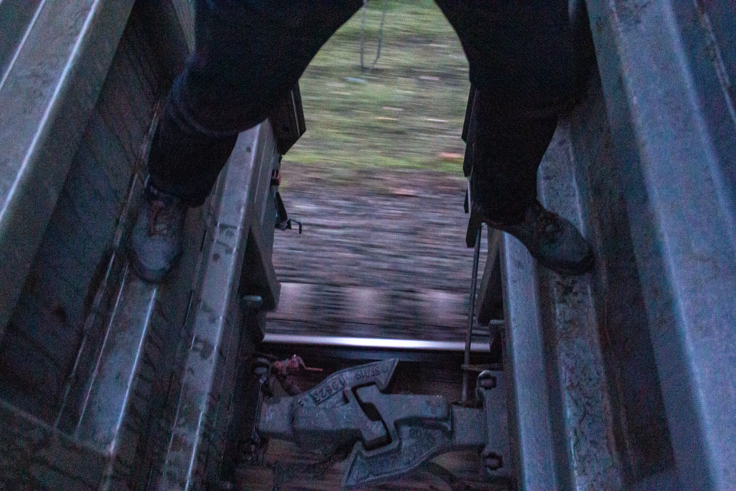 Vanya in the interwagon space. The ladders inside the wagons are usually broken, so the guys climb in between the wagons to admire the view.