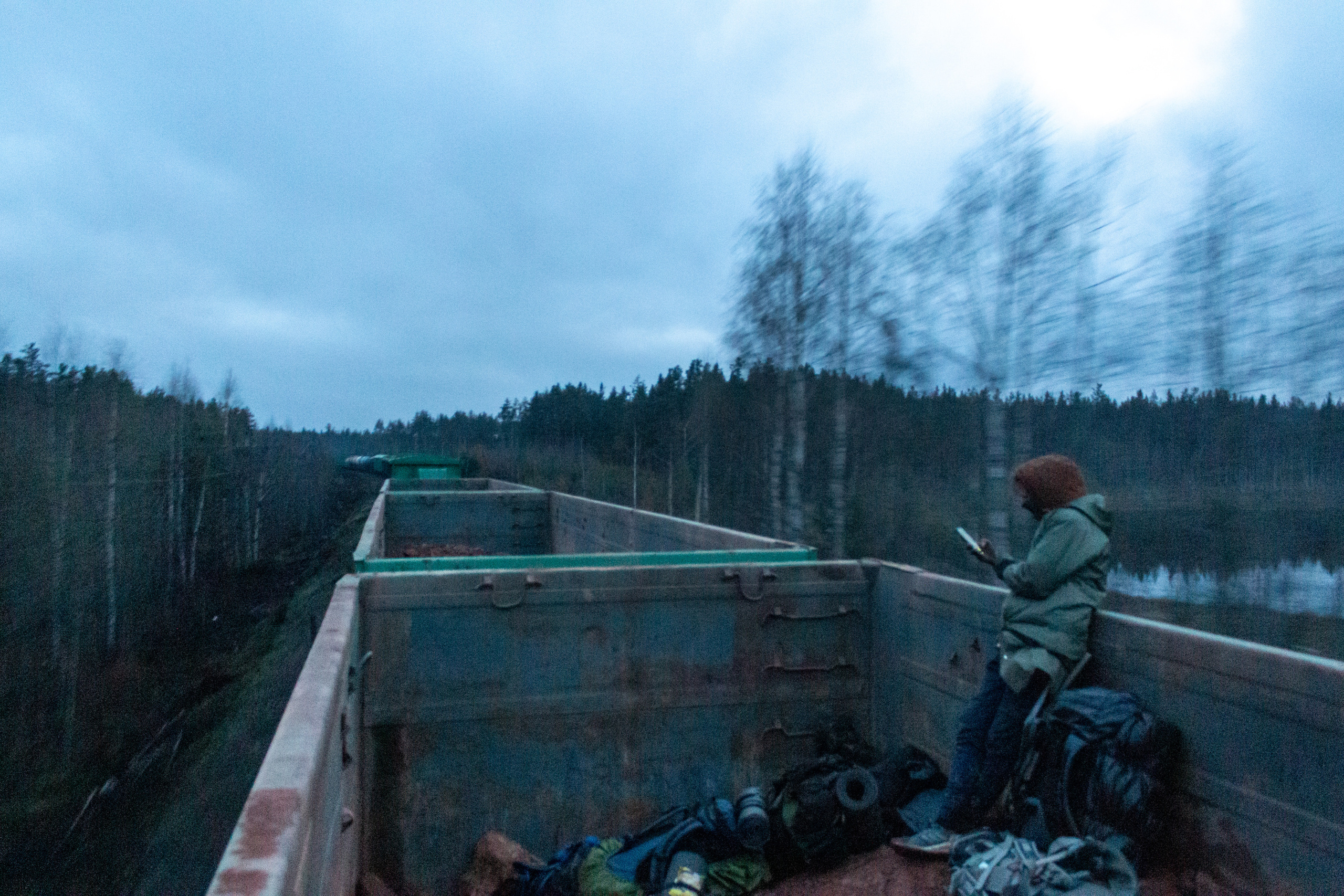 Artem riding the open wagon filled with clay on the way to Saint Petersburgh.