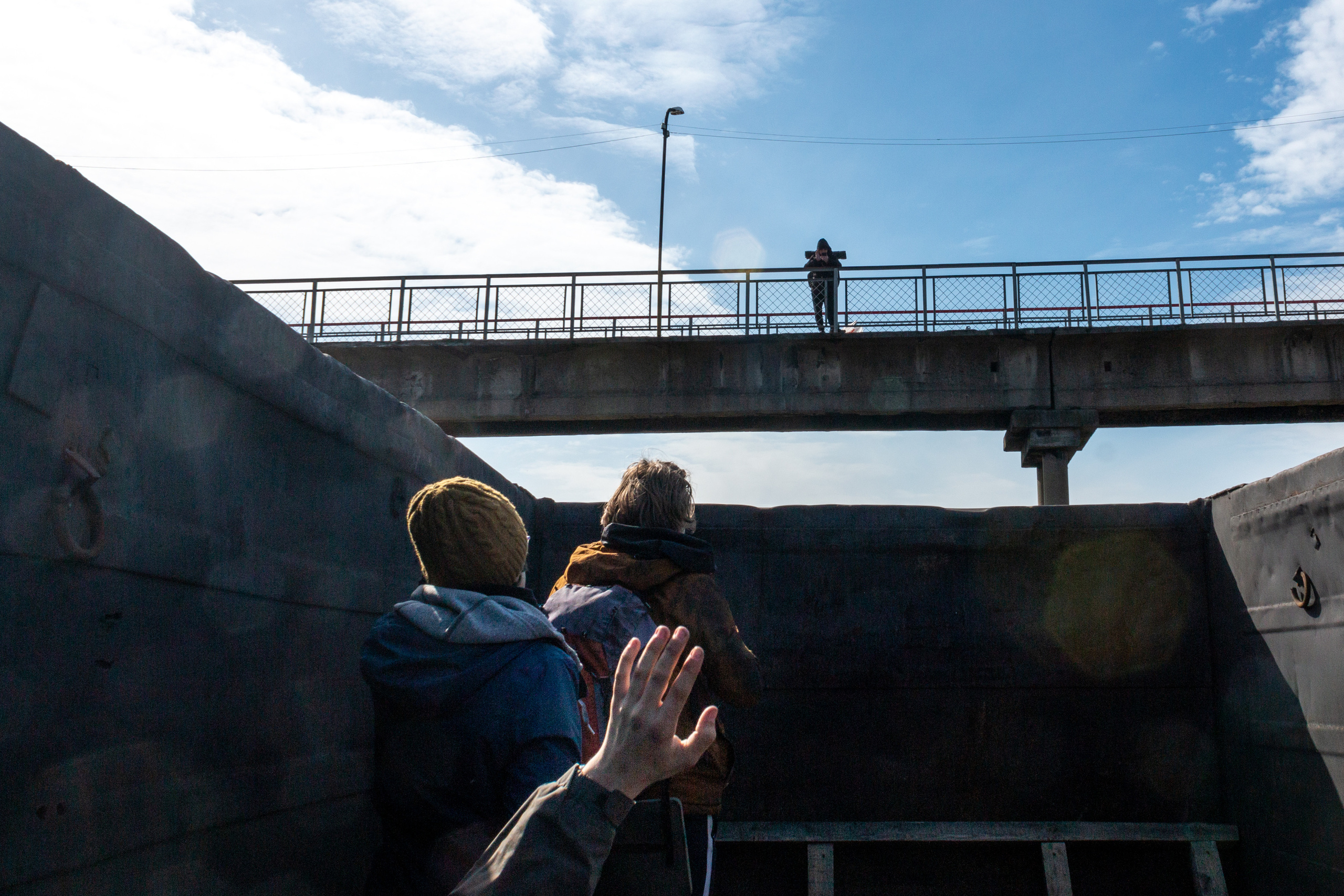 The guys greeting Danya who is standing on the footbridge above. He is going to join them on the trip to Saint Petersburg.