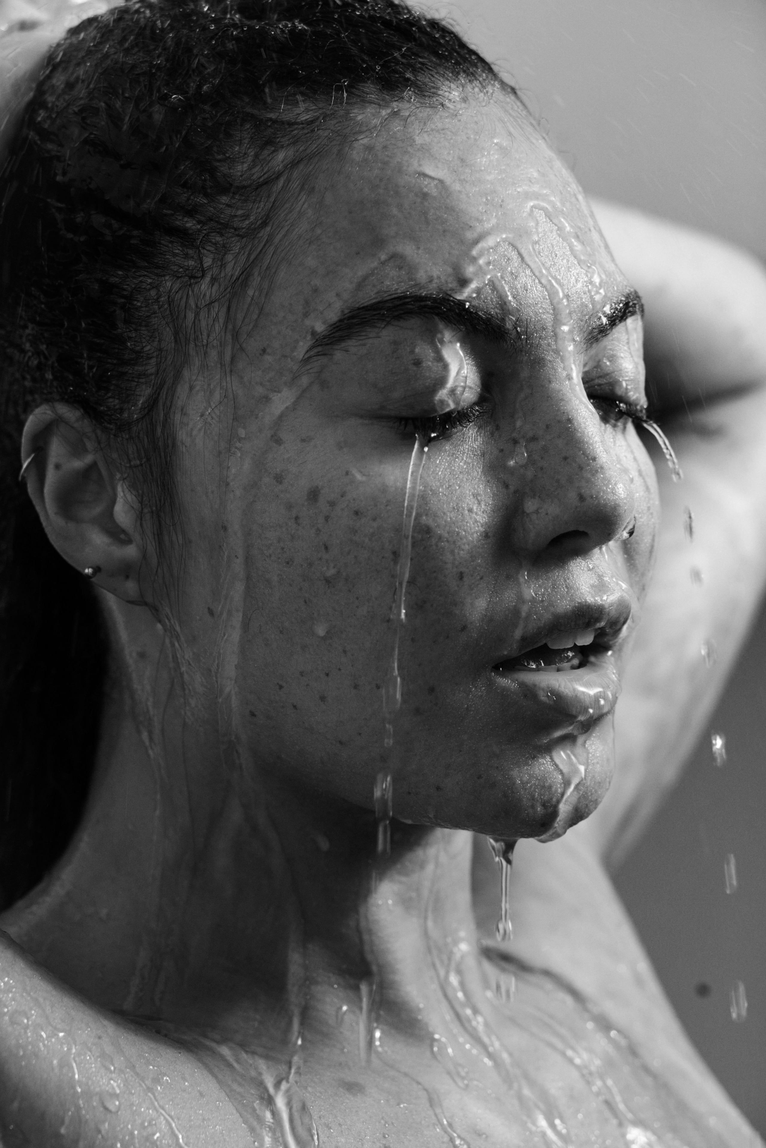 artistic close-up portrait with water on skin, peaceful expression
