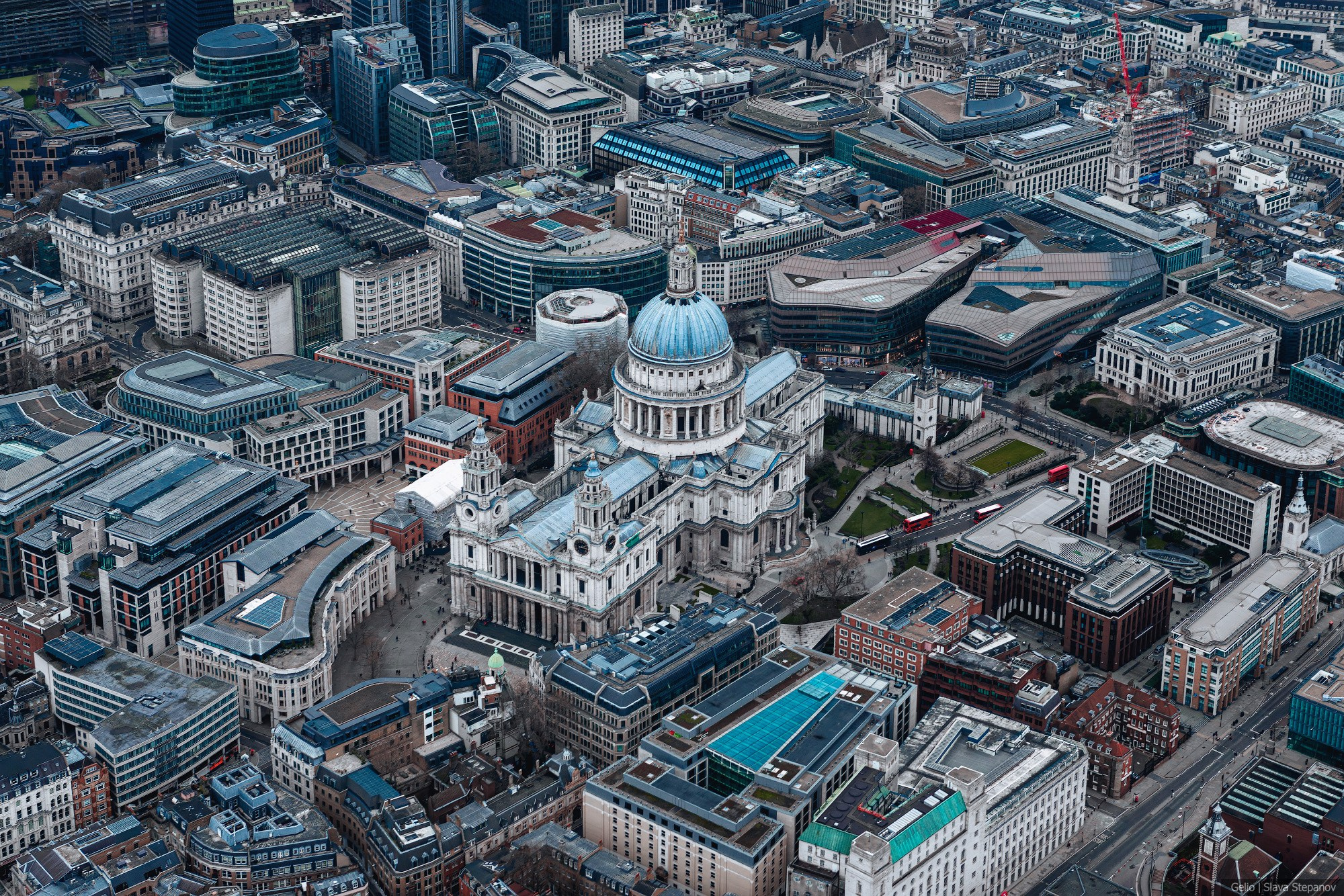 Close-up aerial view of St Paul's Cathedral in London, surrounded by dense urban development. Architectural aerial photography, Gelio.
