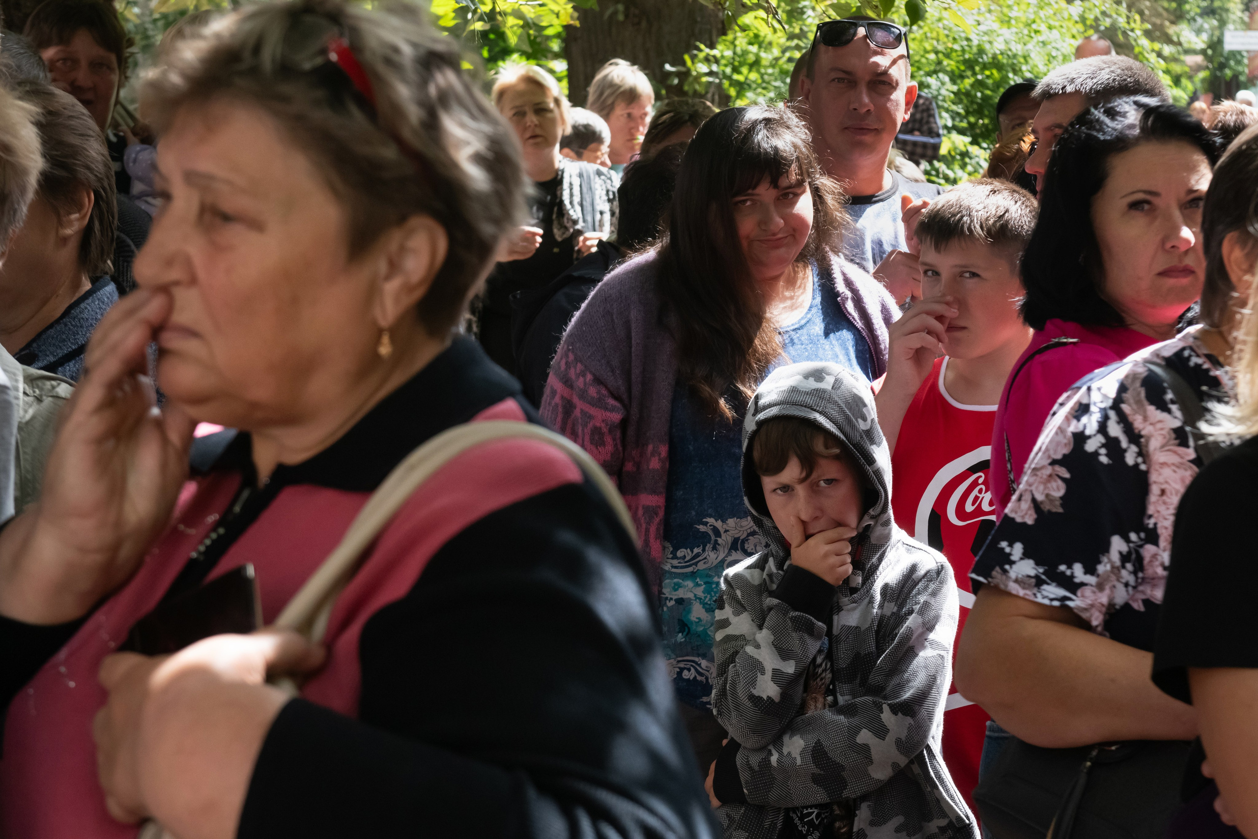 People evacuated from fighting between Russian and Ukrainian forces queue to receive humanitarian aid at a distribution center in Kursk, Russia, Monday, Aug. 12, 2024. (AP Photo)