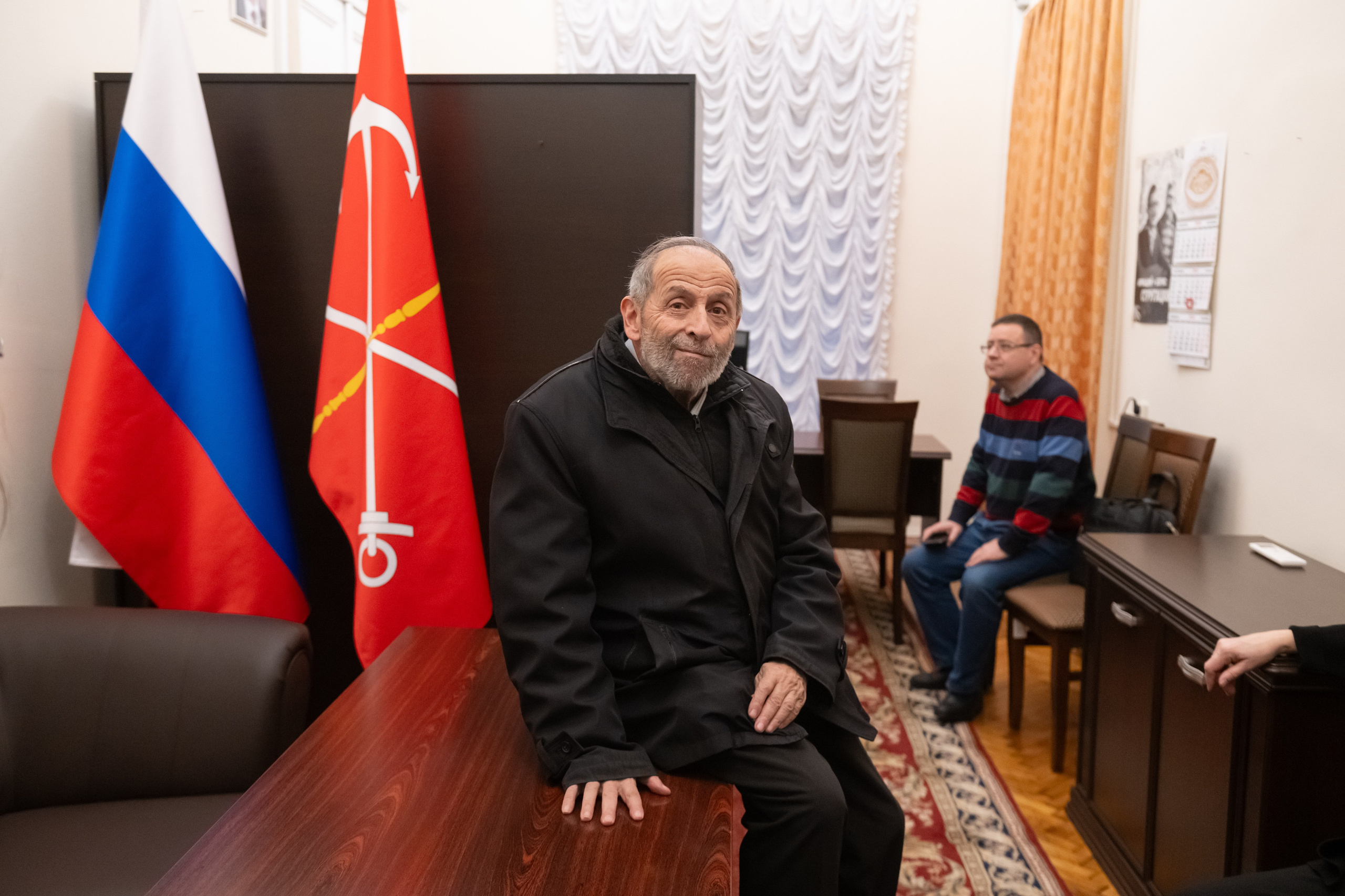 Boris Vishnevsky sits before leaving his office, having gathered his personal belongings.