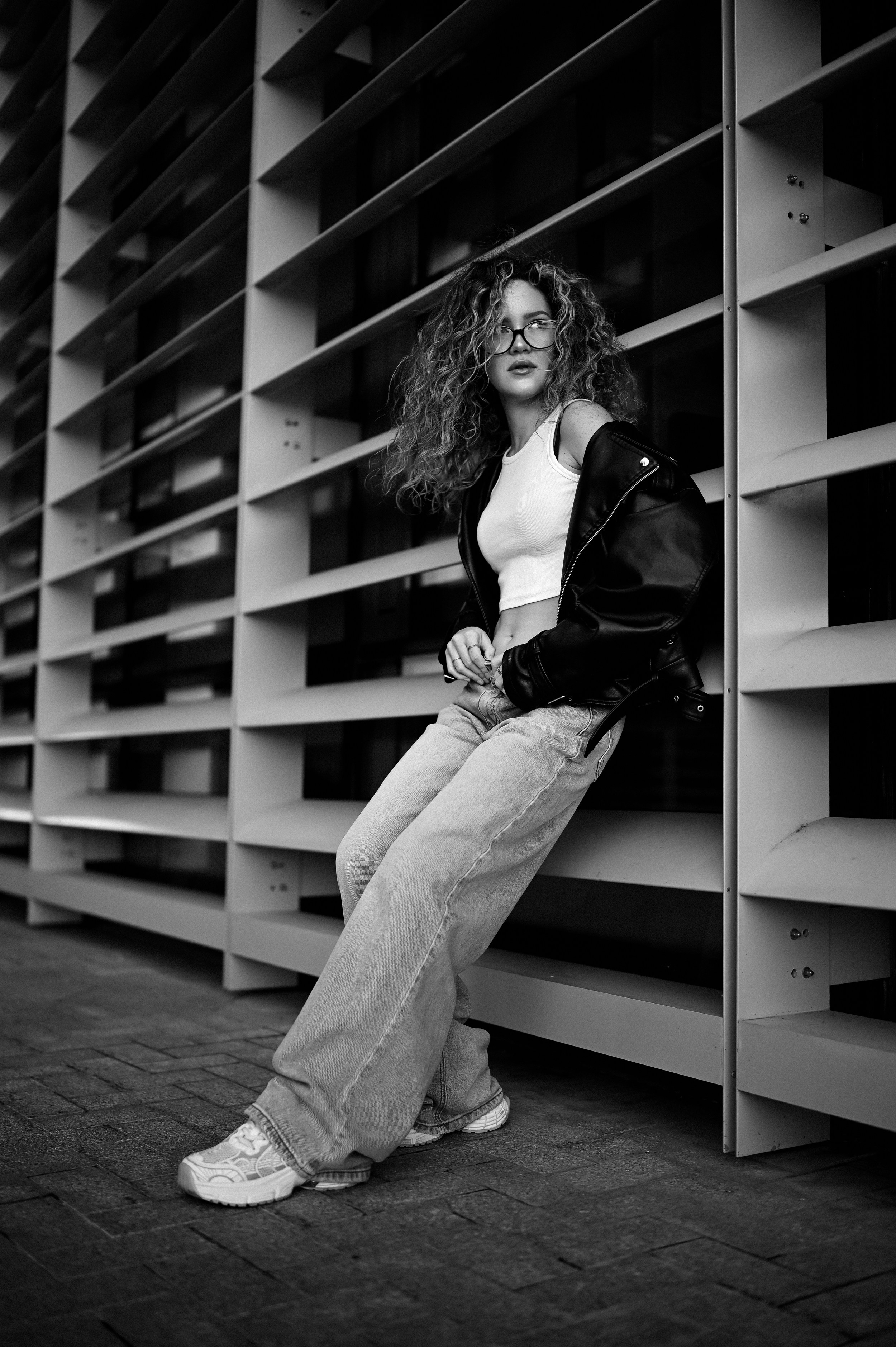 Чёрно-белая фотография девушки в уличной фотосессии в Казани с акцентом на архитектурные линии от Алексея Клейменова