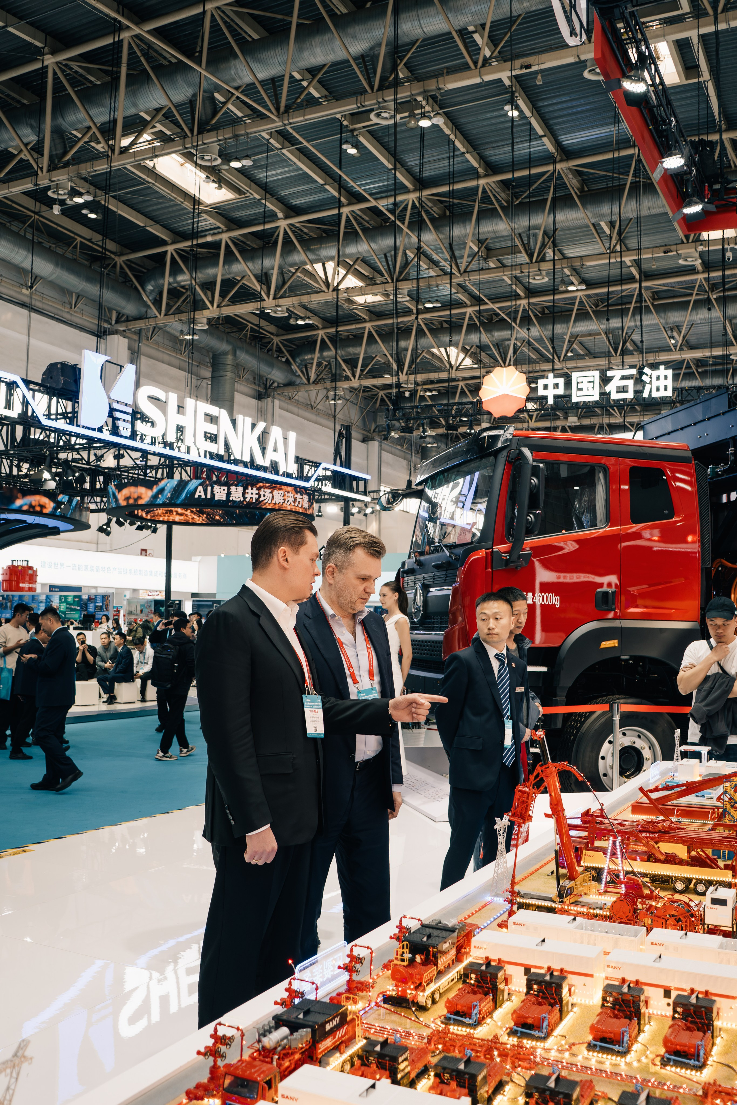 Oil Resource delegation at the cippe exhibition in China, participants discussing what they saw, reportage shot.