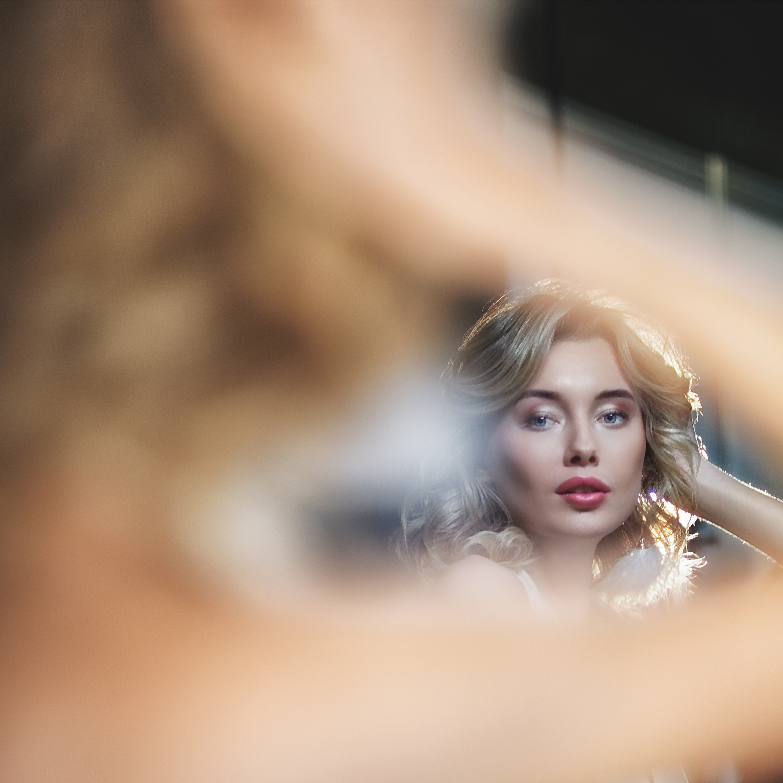 Девушка смотрит на свое отражение в зеркале