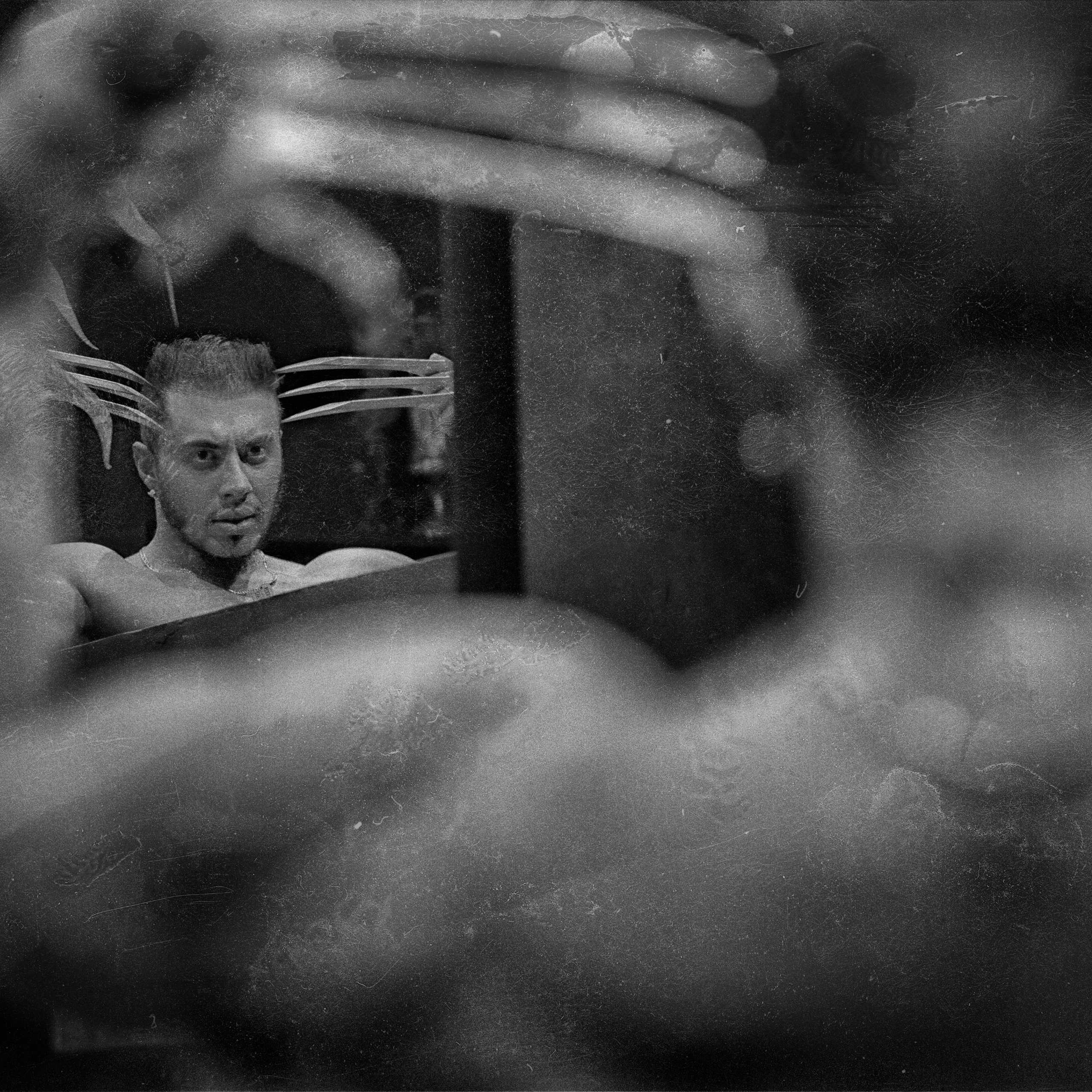 На фотографии запечатлен мужчина, стоящий перед зеркалом. Его отражение видно в зеркале, а руки создают рамку вокруг его головы. Снимок выполнен в черно-белом стиле, что придает ему драматичность и художественную глубину. Атмосфера снимка загадочная и интроспективная, подчеркивающая внутренний мир героя.Заголовок: «Отражение души: искусство черно-белой фотографии»Ключевые слова: портретный фотограф в Москве, фотограф Сафронов Иван.