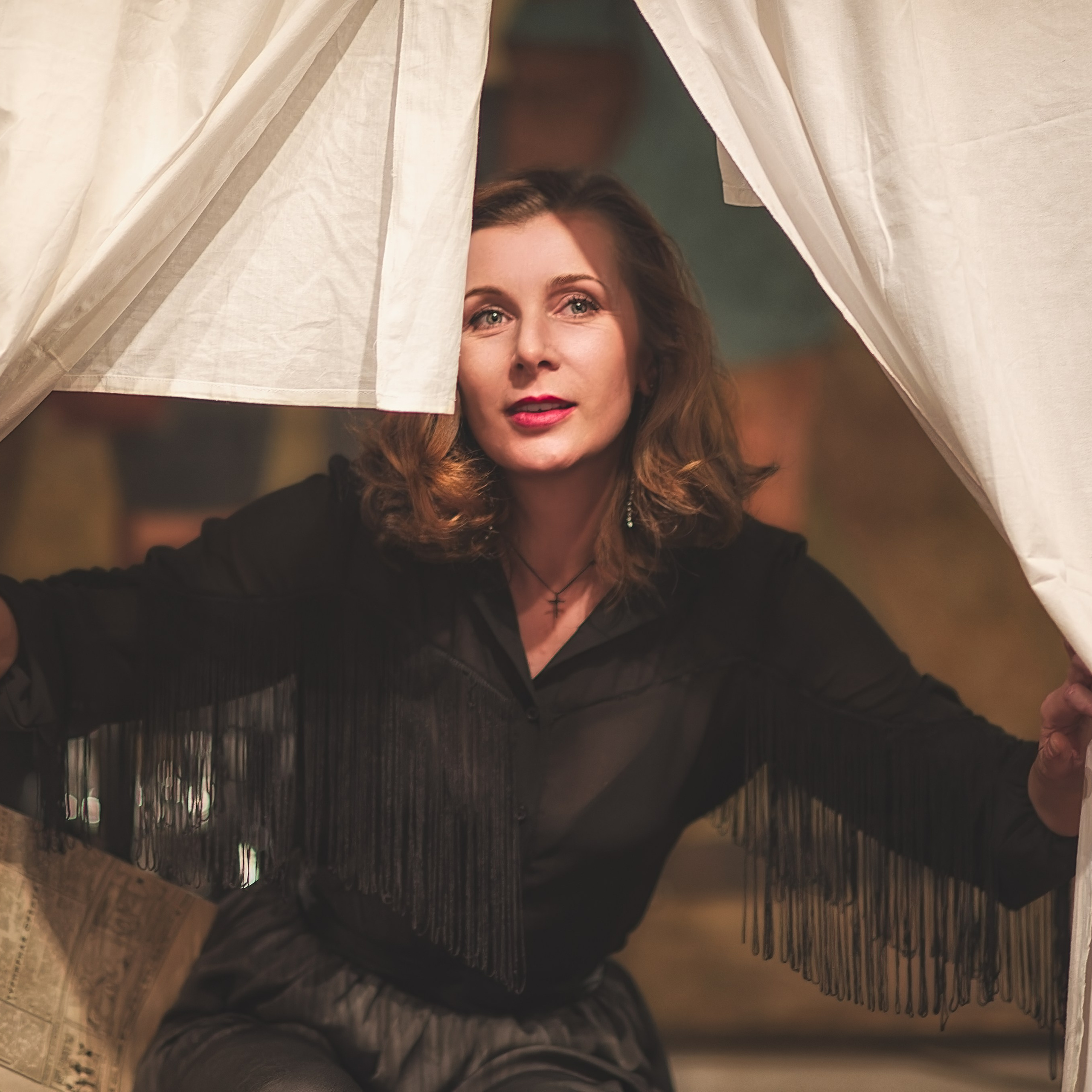 Девушка выглядывает из-за простыни