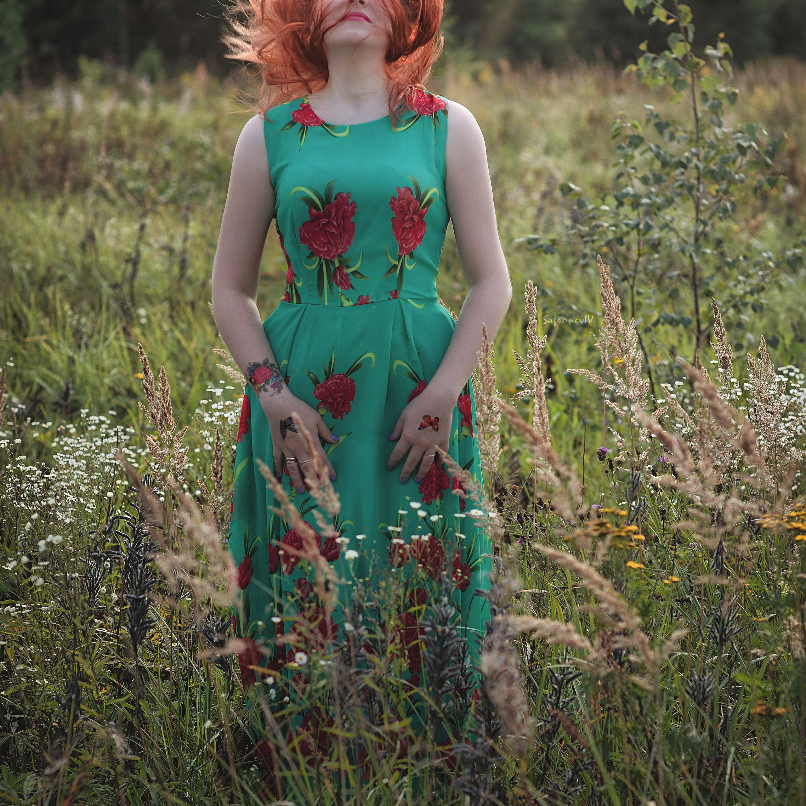 Рыжая девушка в зеленом платье на русском поле