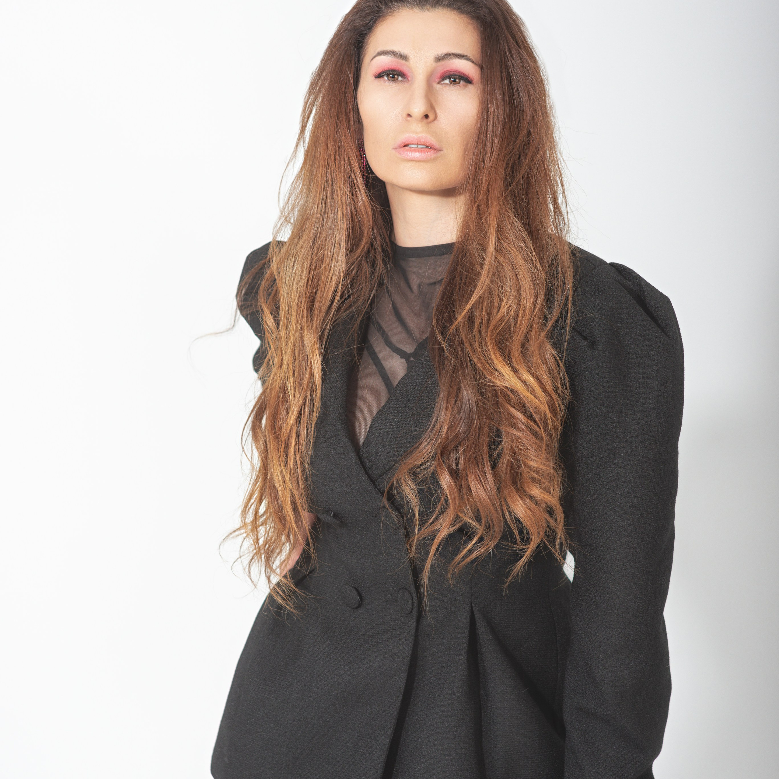 женщина с длинными волнистыми волосами, одетая в черный пиджак с рукавами-фонариками и бордовые колготки. Она позирует на светлом фоне, создавая элегантный и стильный образ.Заголовок: «Элегантность в каждом движении»Ключевые слова: портрет, стиль, мода, черный пиджак, бордовые колготки, рукава-фонарики, фотограф Сафронов Иван, Москва.