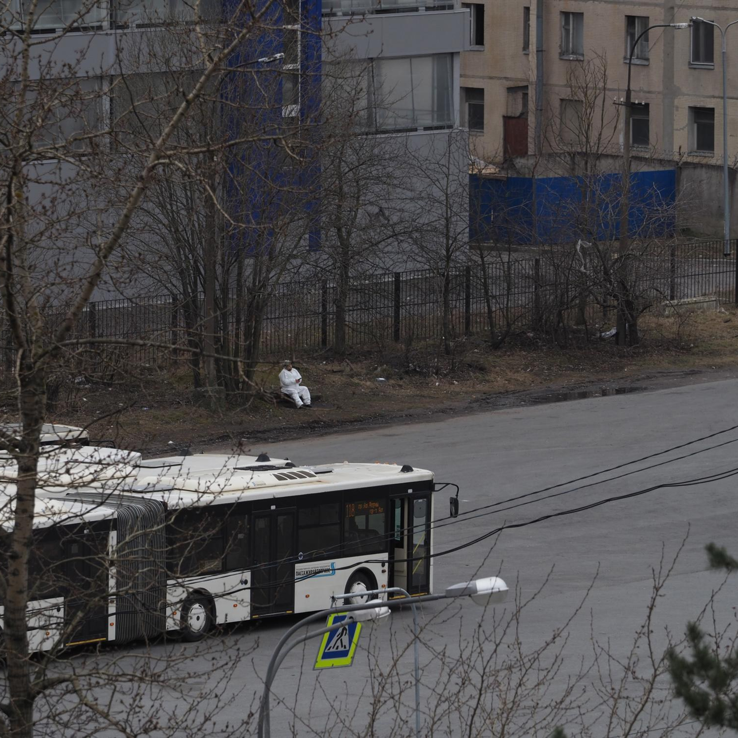 April 6, 2020, A bus depot worker is resting while waiting for the next bus to return from its route. Each bus was sanitized after returning to the depot.