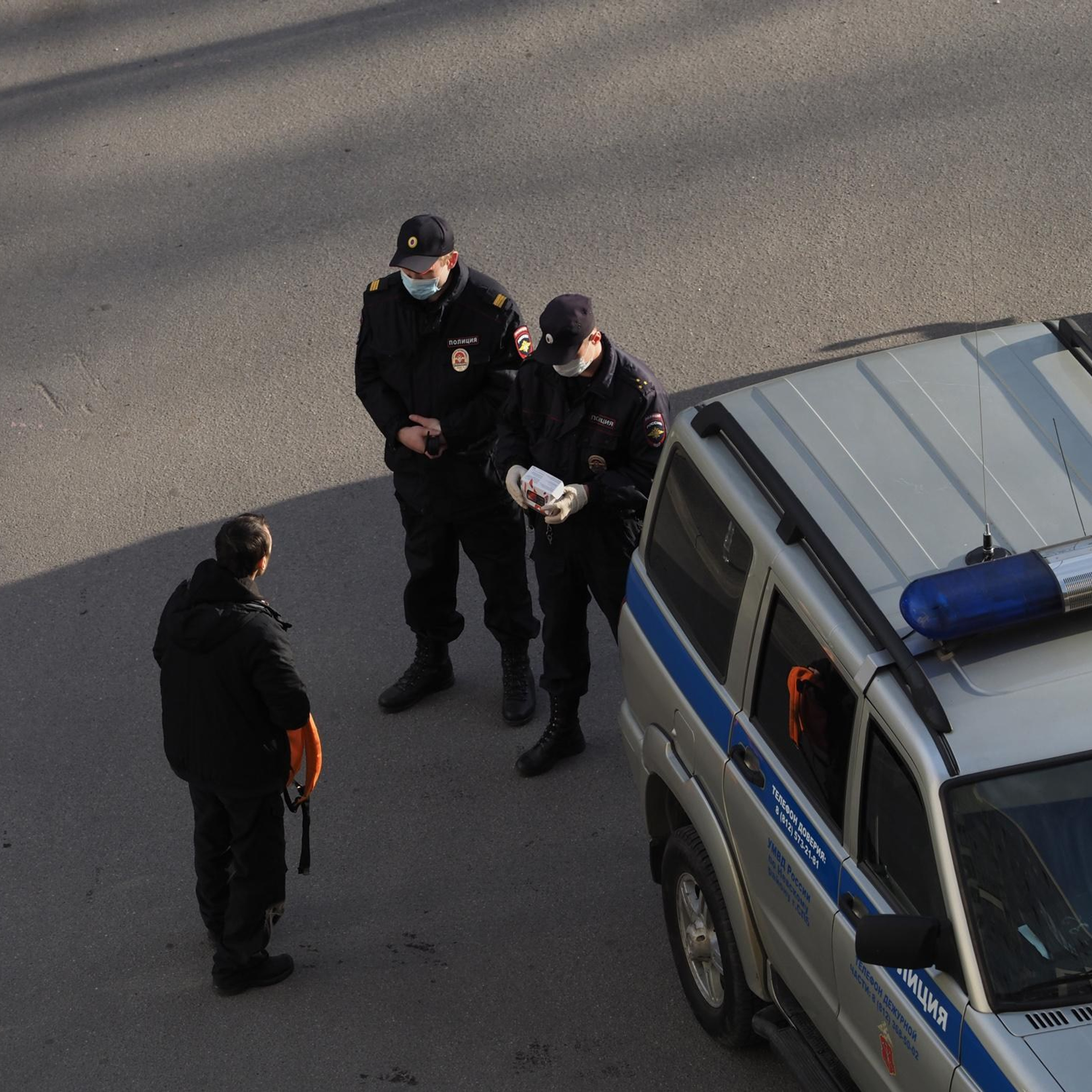 April 21, 2020, Police officers check the documents of a young man and inquire about his purpose for being on the street.