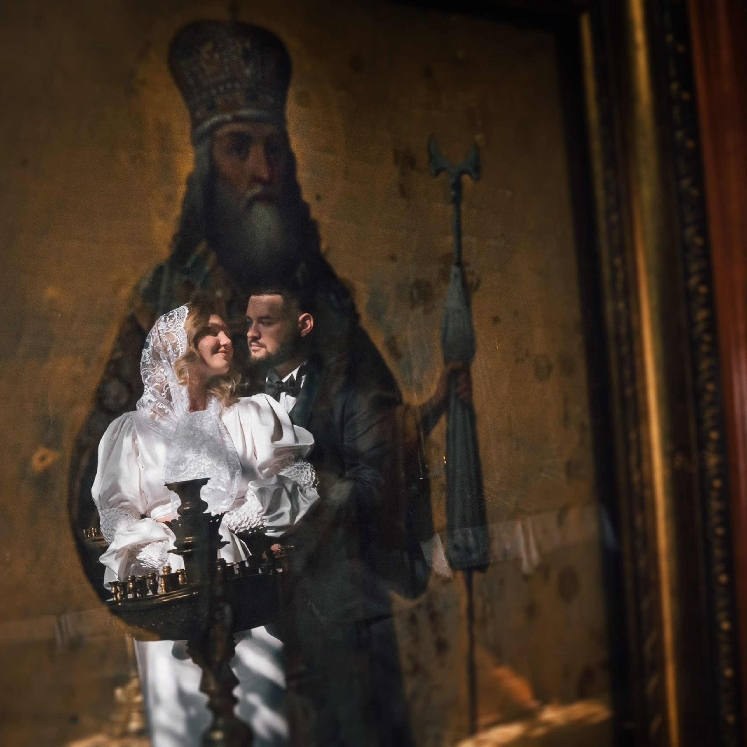 Жених и невеста в храме после православного венчания отражение