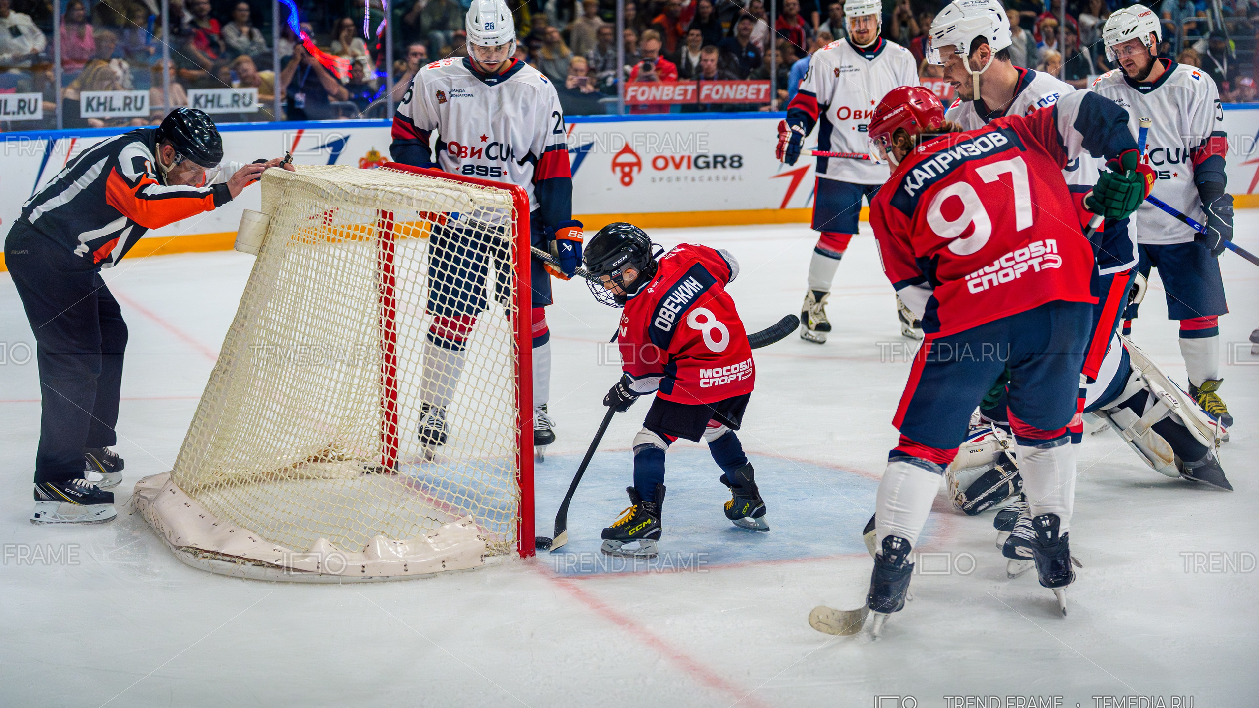 фото хоккея — сын Александра Овечкина с шайбой у ворот, рядом Кирилл Капризов, игроки команды Павла Дацюка в обороне — Кубок Овечкина 2025 — TrendFrame