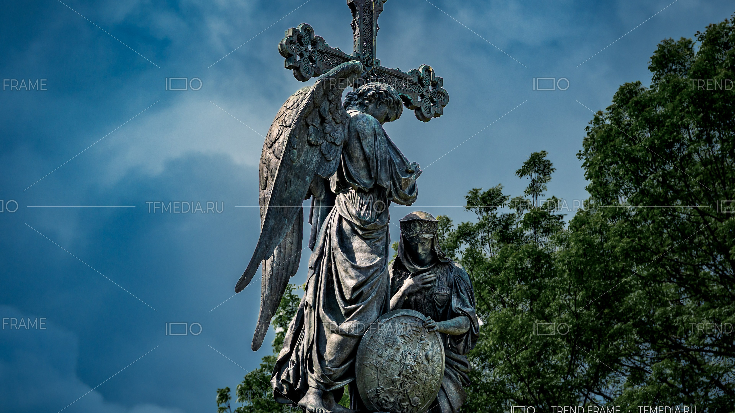 Памятник с ангелом и крестом на фоне неба — архитектурная фотосъёмка в Великом Новгороде