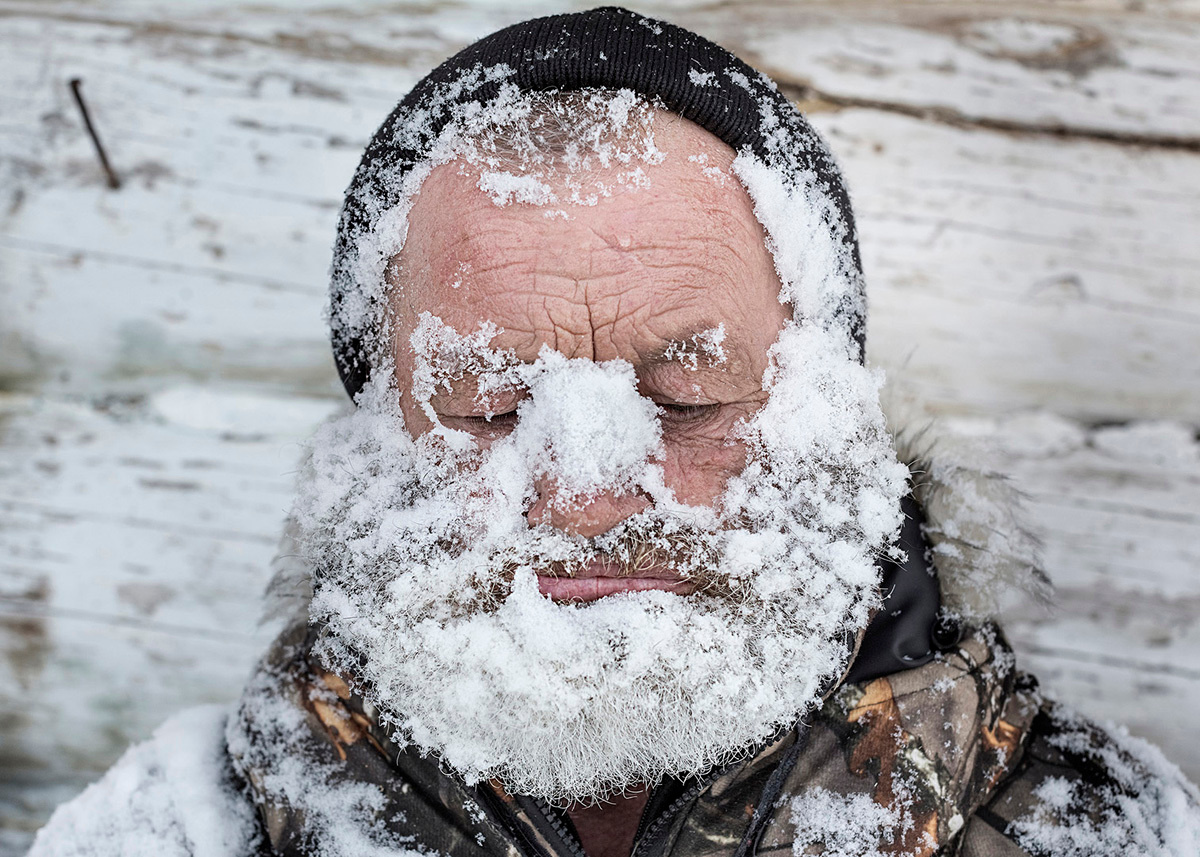 Local hunter washes his face with snow. Far North, Siberia by Elena Anosova
