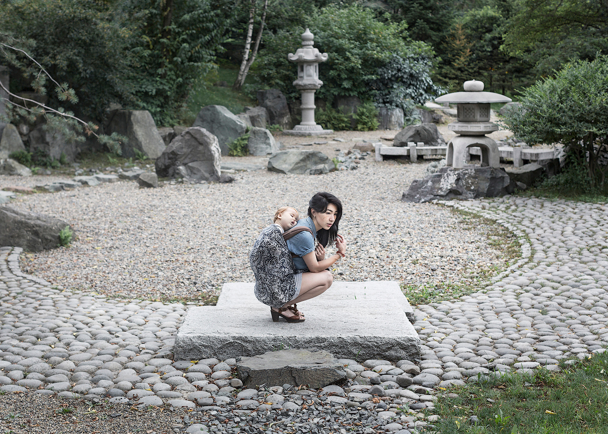 A young mother on a walk in a park of Vladivostok, Far East 2015