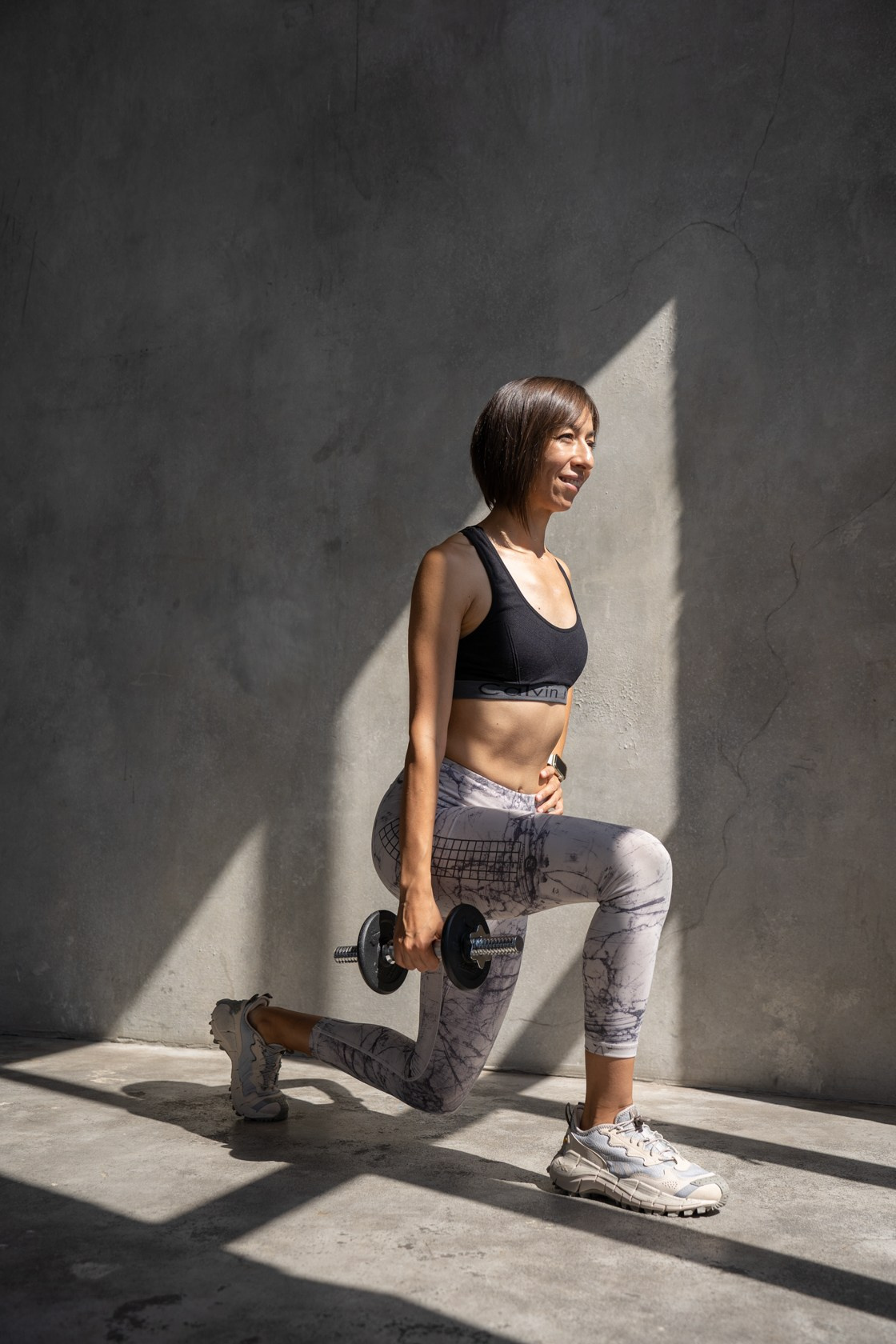 фитнес-тренер в студии с гантелями