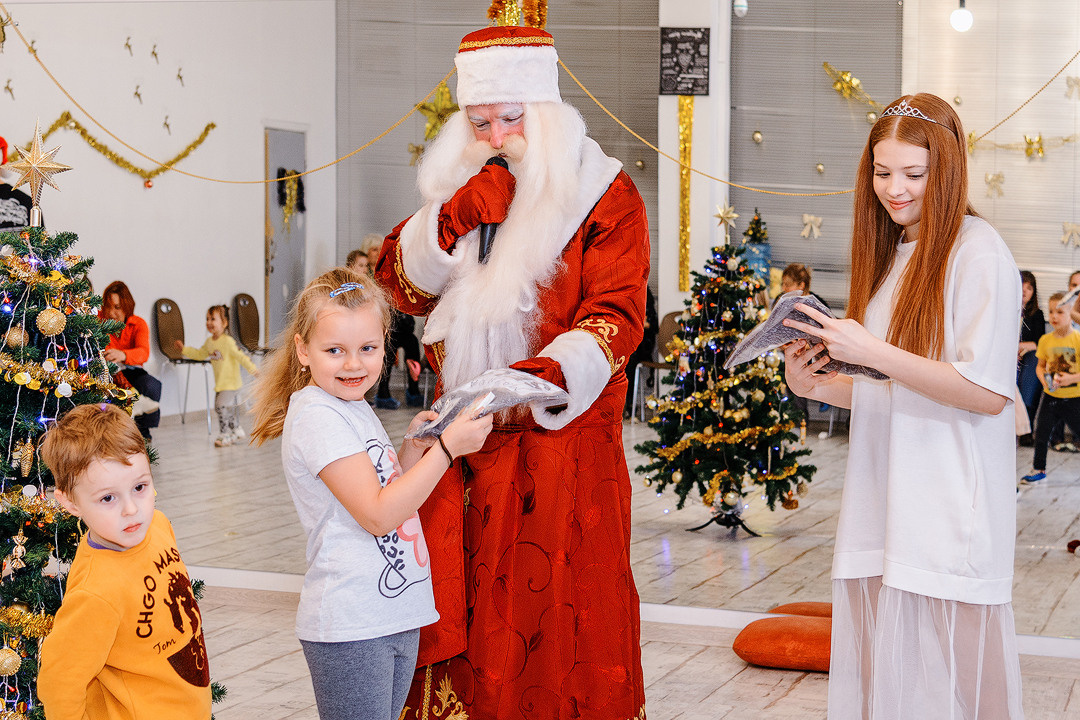 Дед Мороз общается с девочкой.