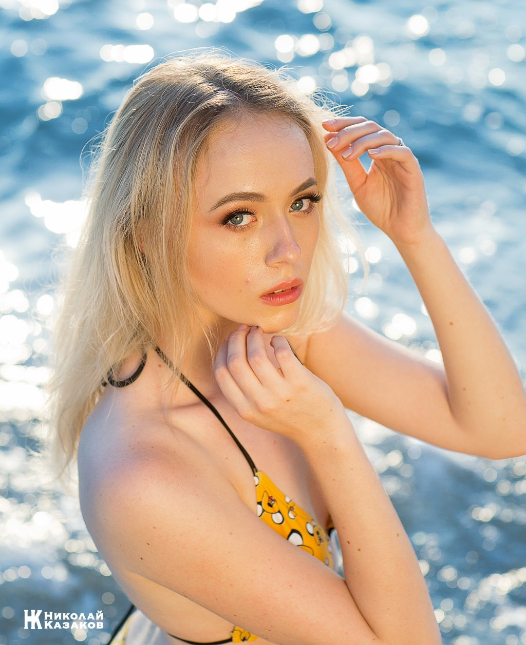 Портрет нежной молодой женщины в бикини на фоне бирюзового моря.