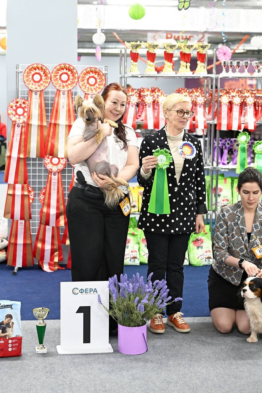 Emma - first place. Photo with an expert on the podium.