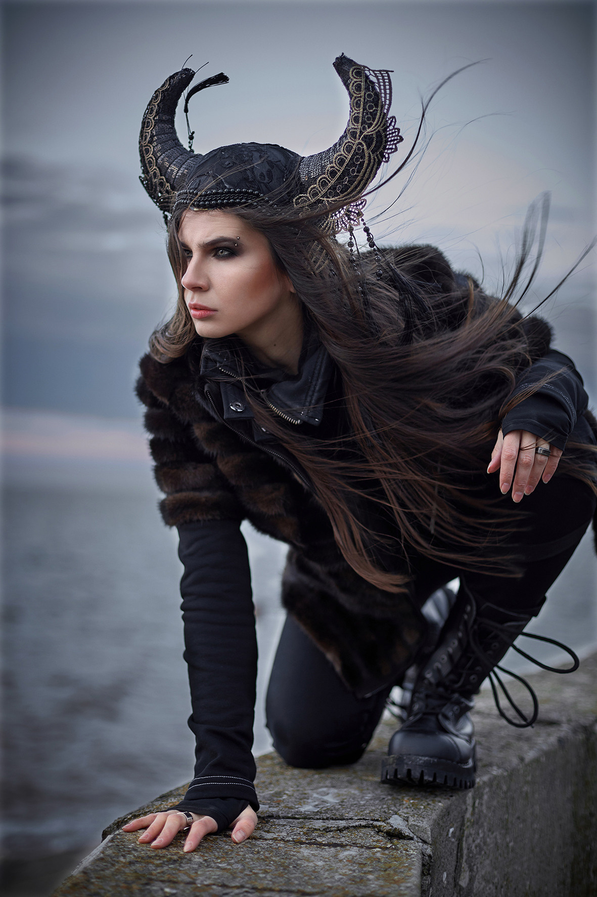 Фэшн портрет девушки в стиле викинга на фоне море в час заката. Морской ветер развевает волосы девушки в головном уборе с рогами. Головной убор с рогами. Фотограф. Тимашевск. Кубань. Краснодарский край.