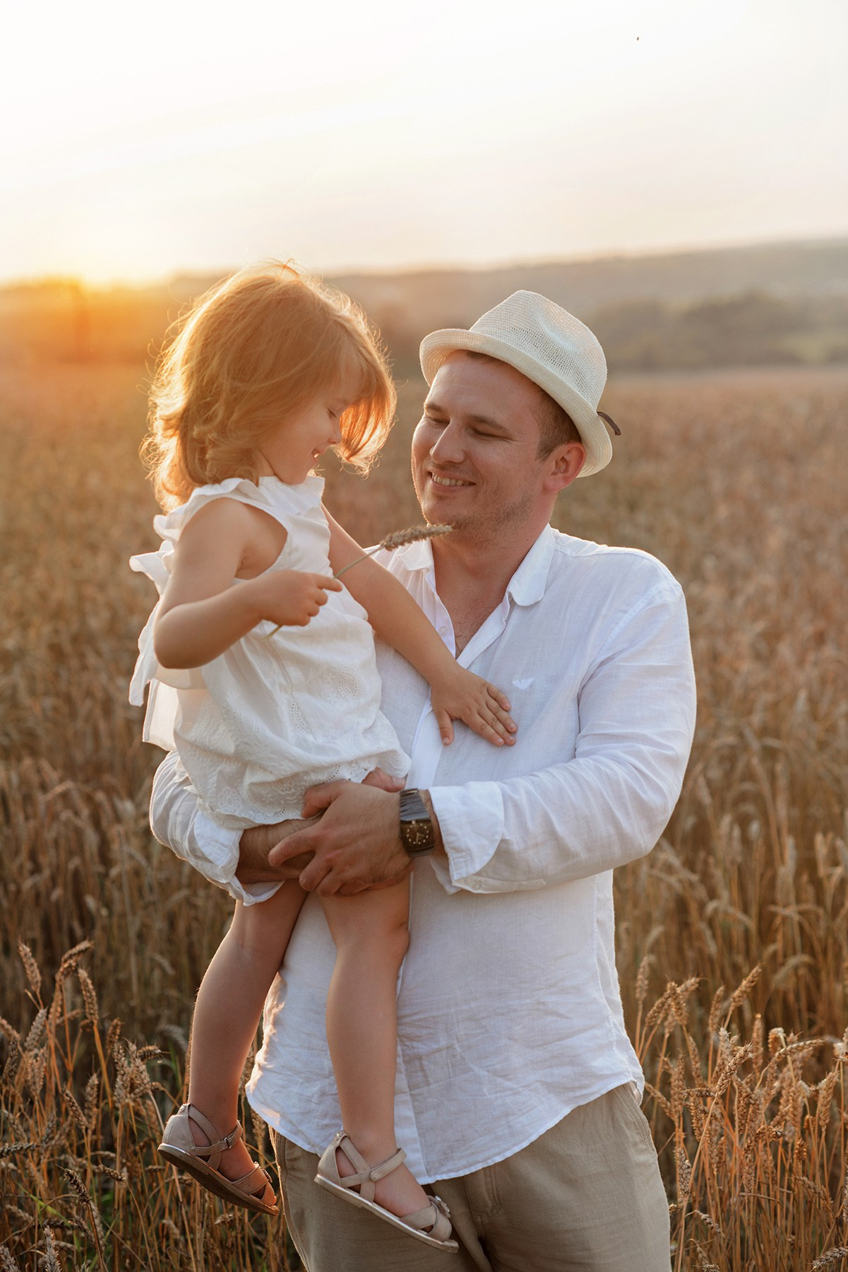 Family photo shoot, in a wheat field at sunset