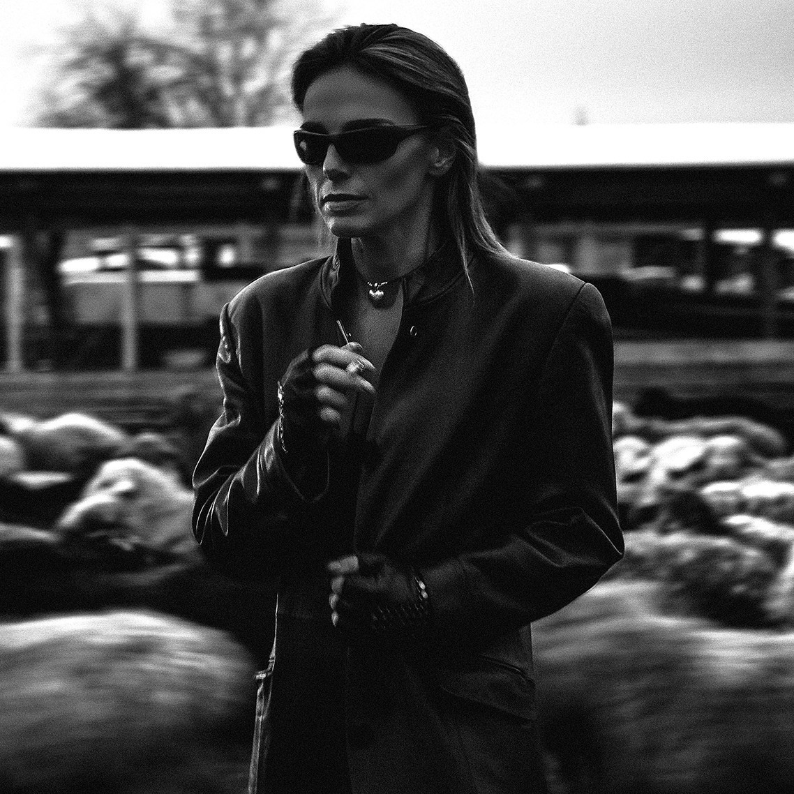 Девушка в загоне с овцами курит сигарету. Съемка на улице с длинной выдержкой Казань