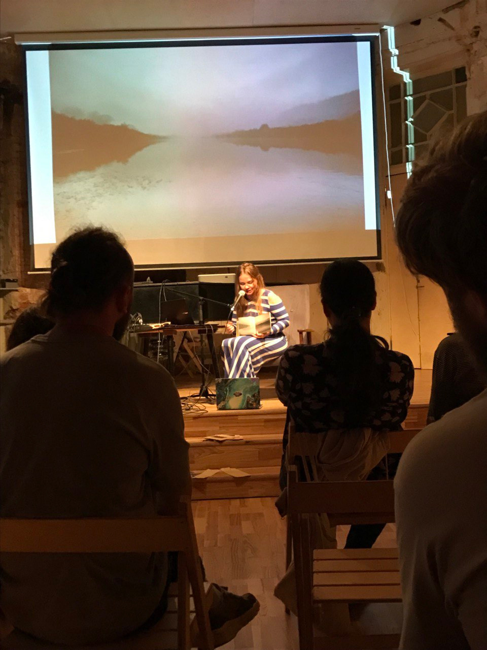 Olga Mikhalchuk is telling the audience the history of “The HARD” book. Olga Mikhalchuk, visual artist